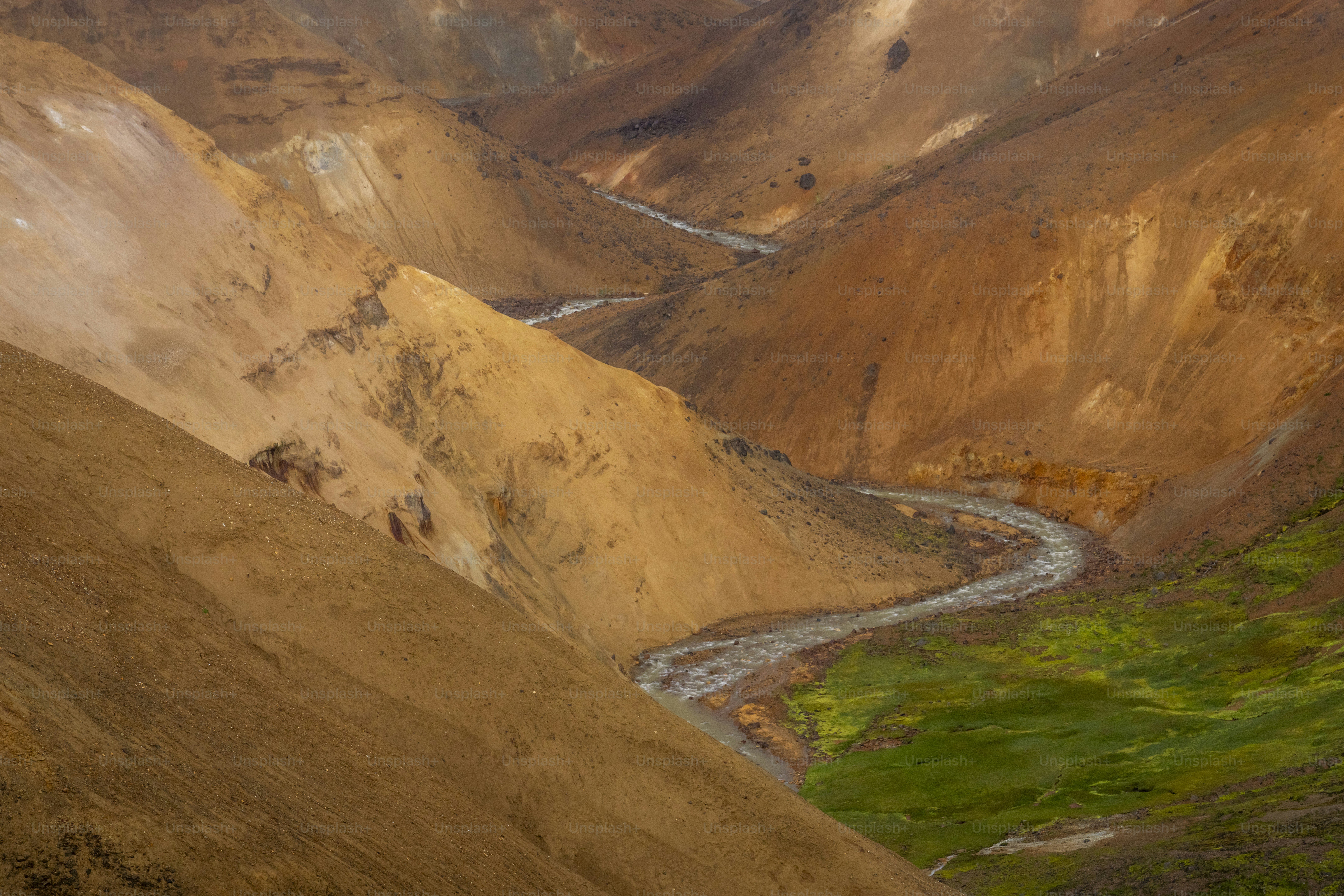Winding river in orange mountain valley - Photo on Unsplash+