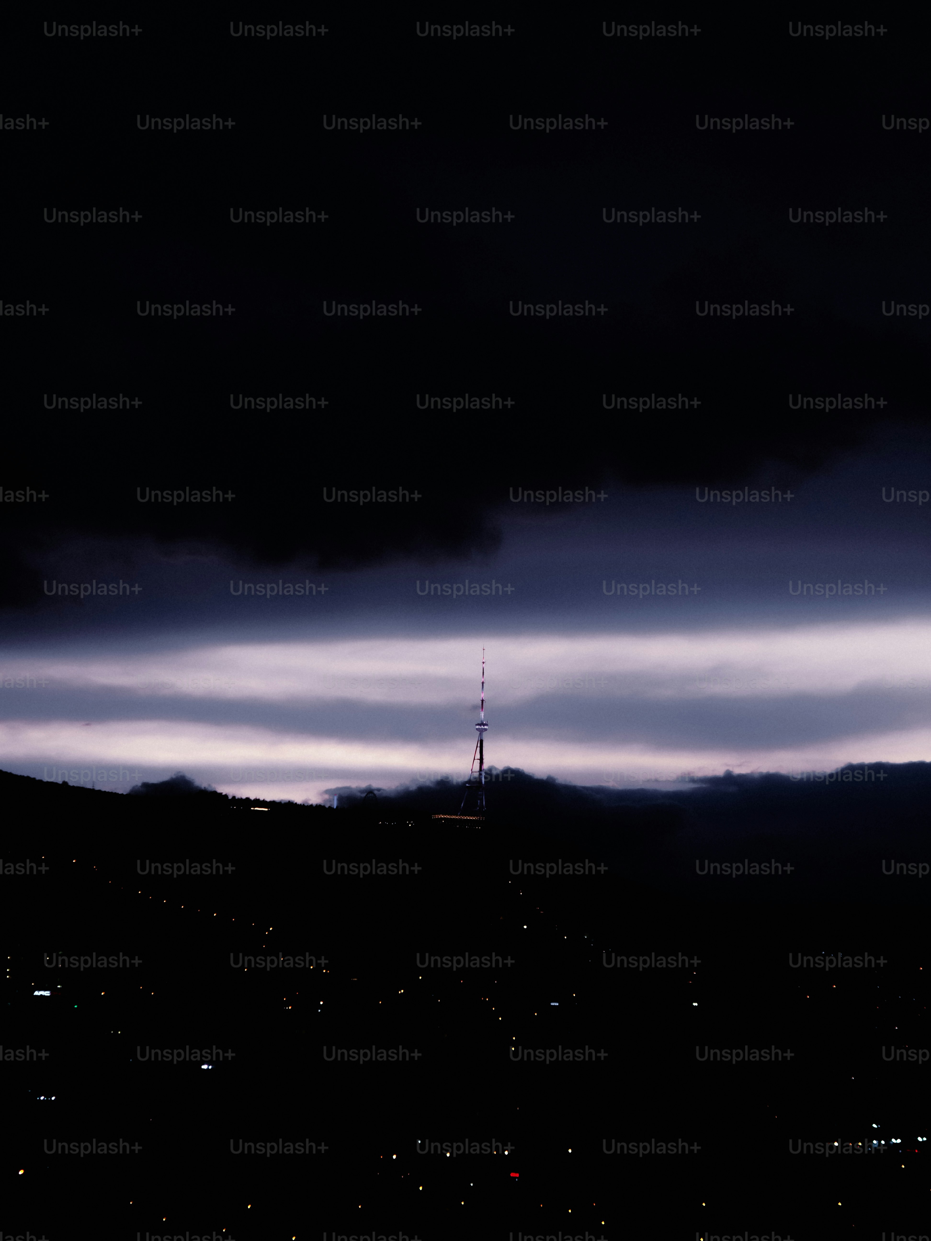 Television tower above city at night - Photo on Unsplash+