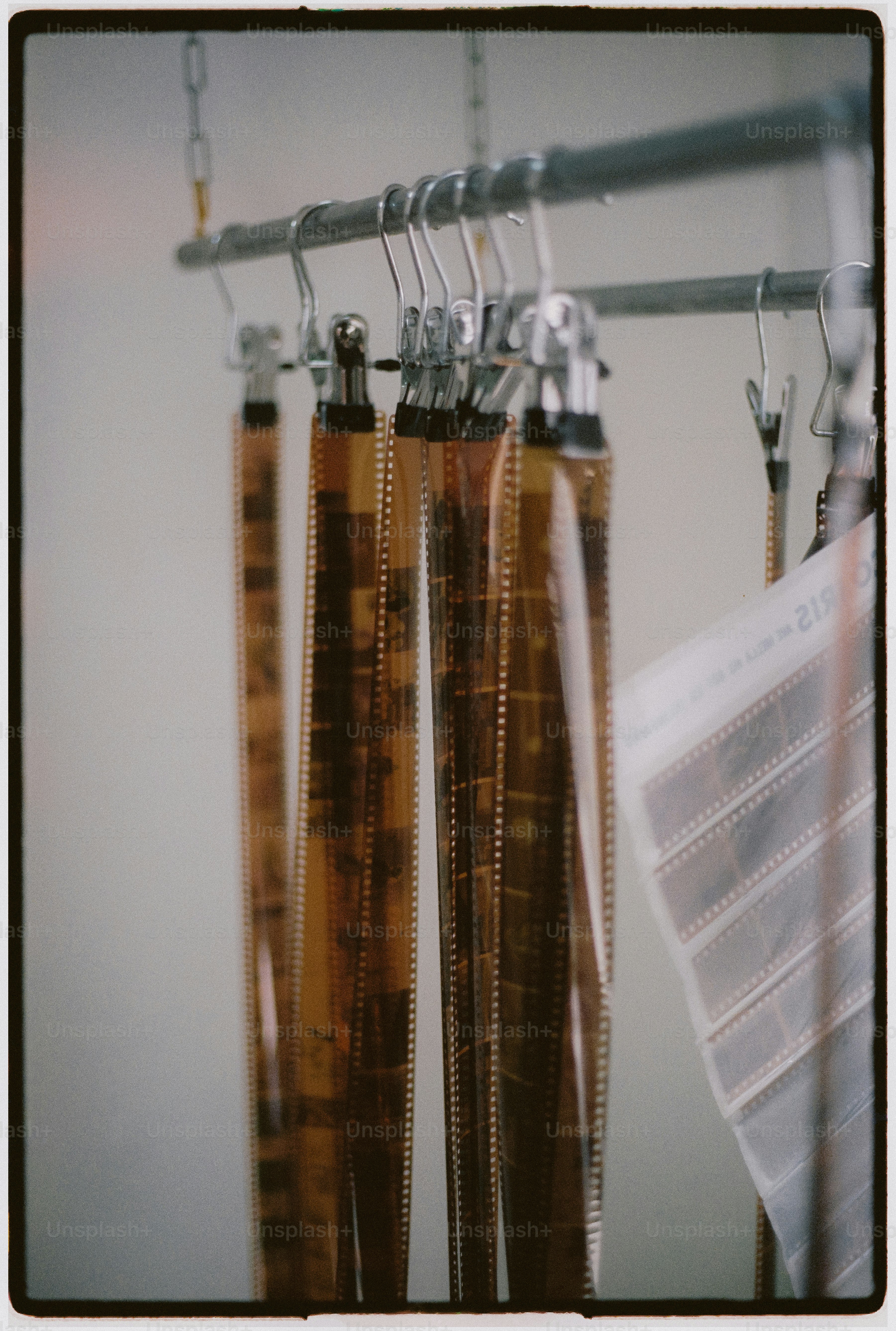 Developed film strips on drying rack - Photo on Unsplash+