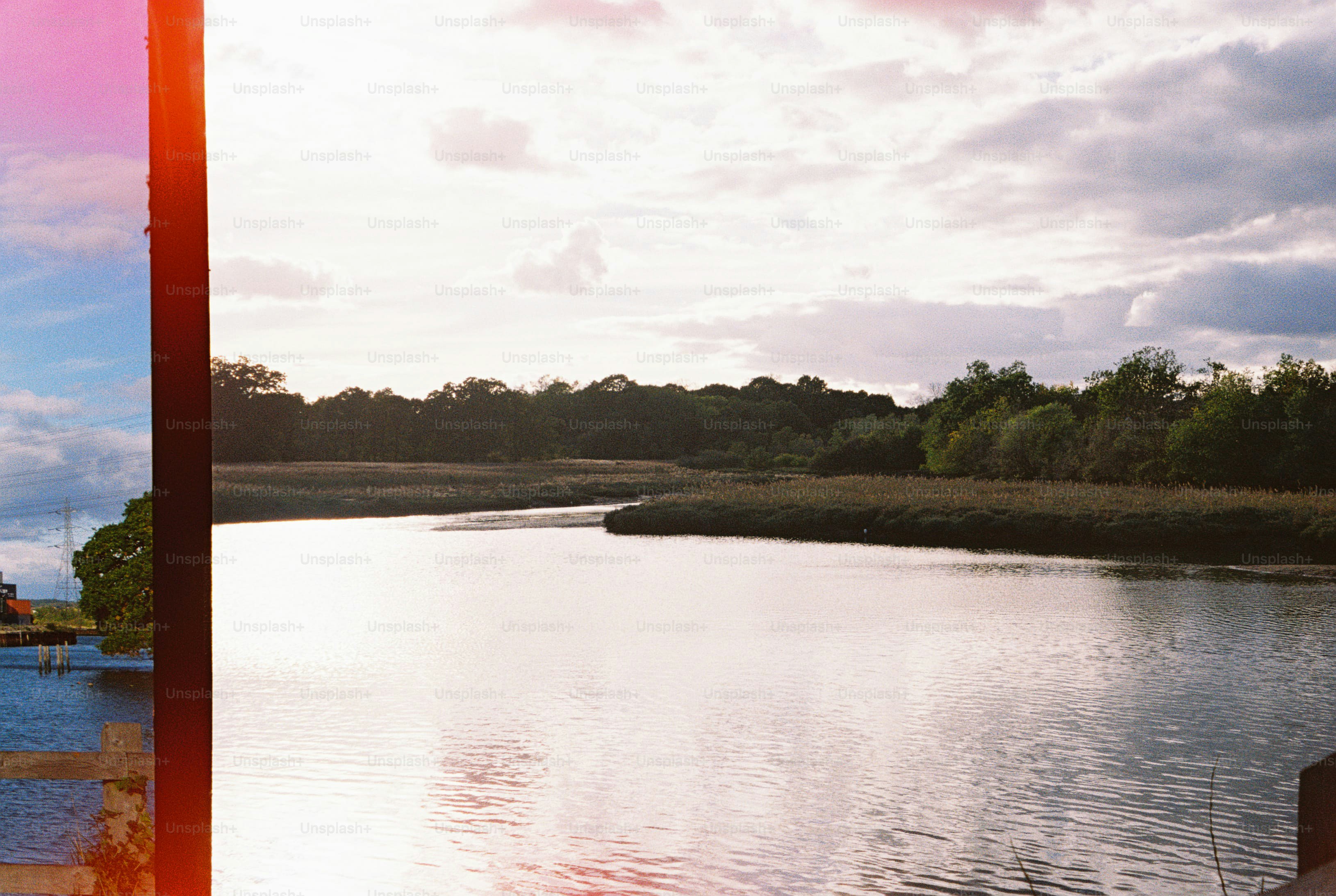 Wide river under cloudy sky - Photo on Unsplash+