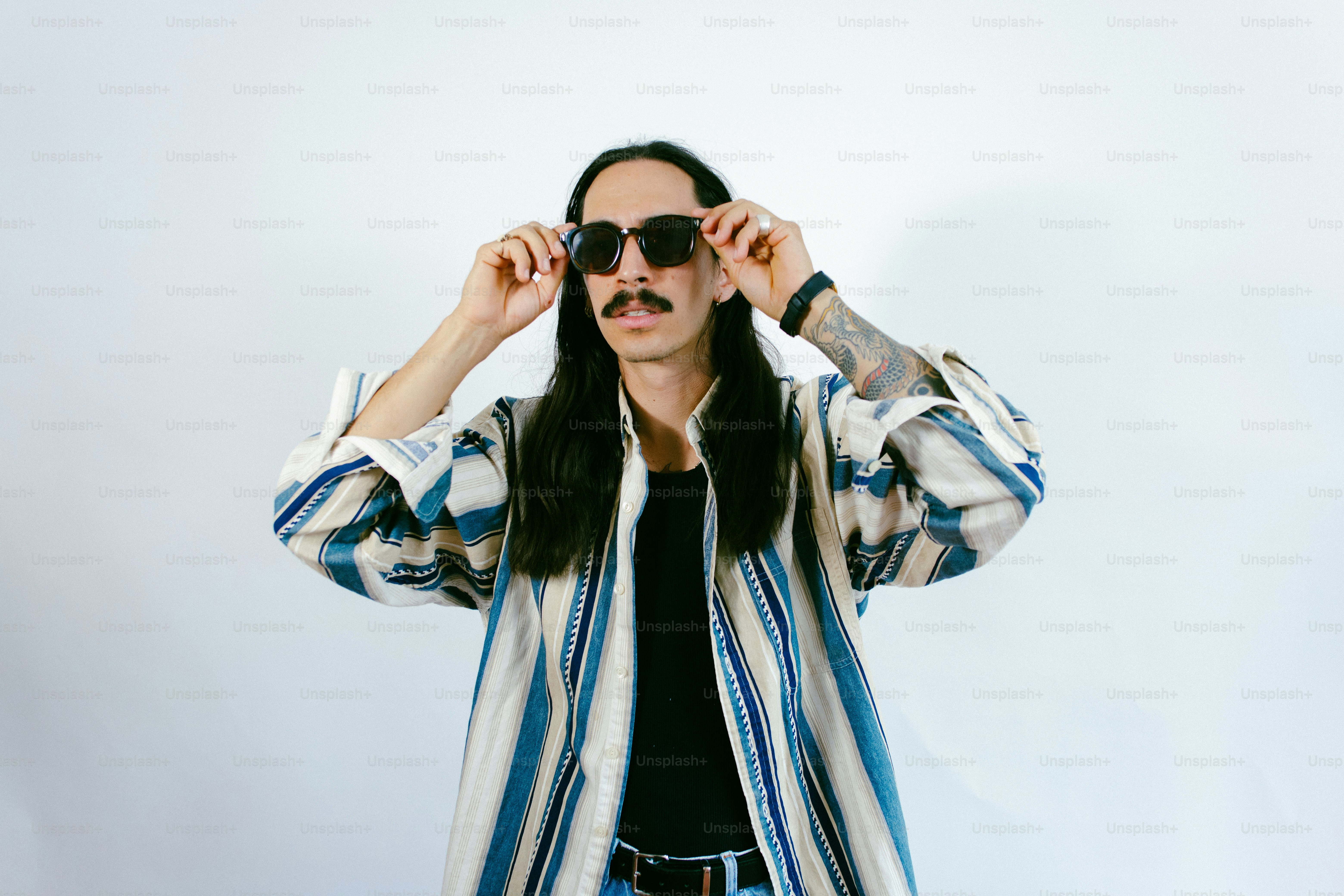 Man with mustache wearing striped shirt - Photo on Unsplash+