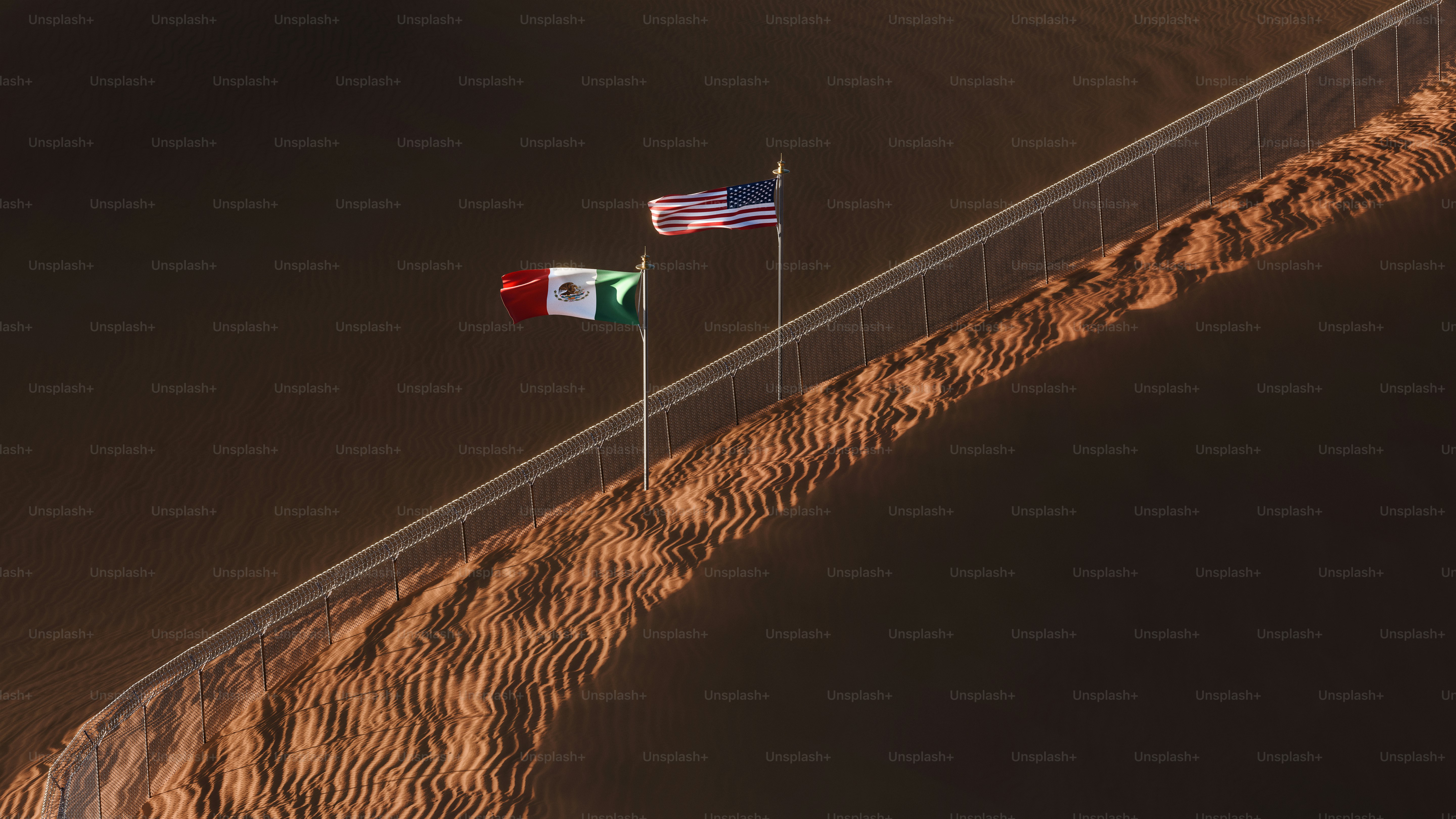 Border fence and flags on dunes - Photo on Unsplash+