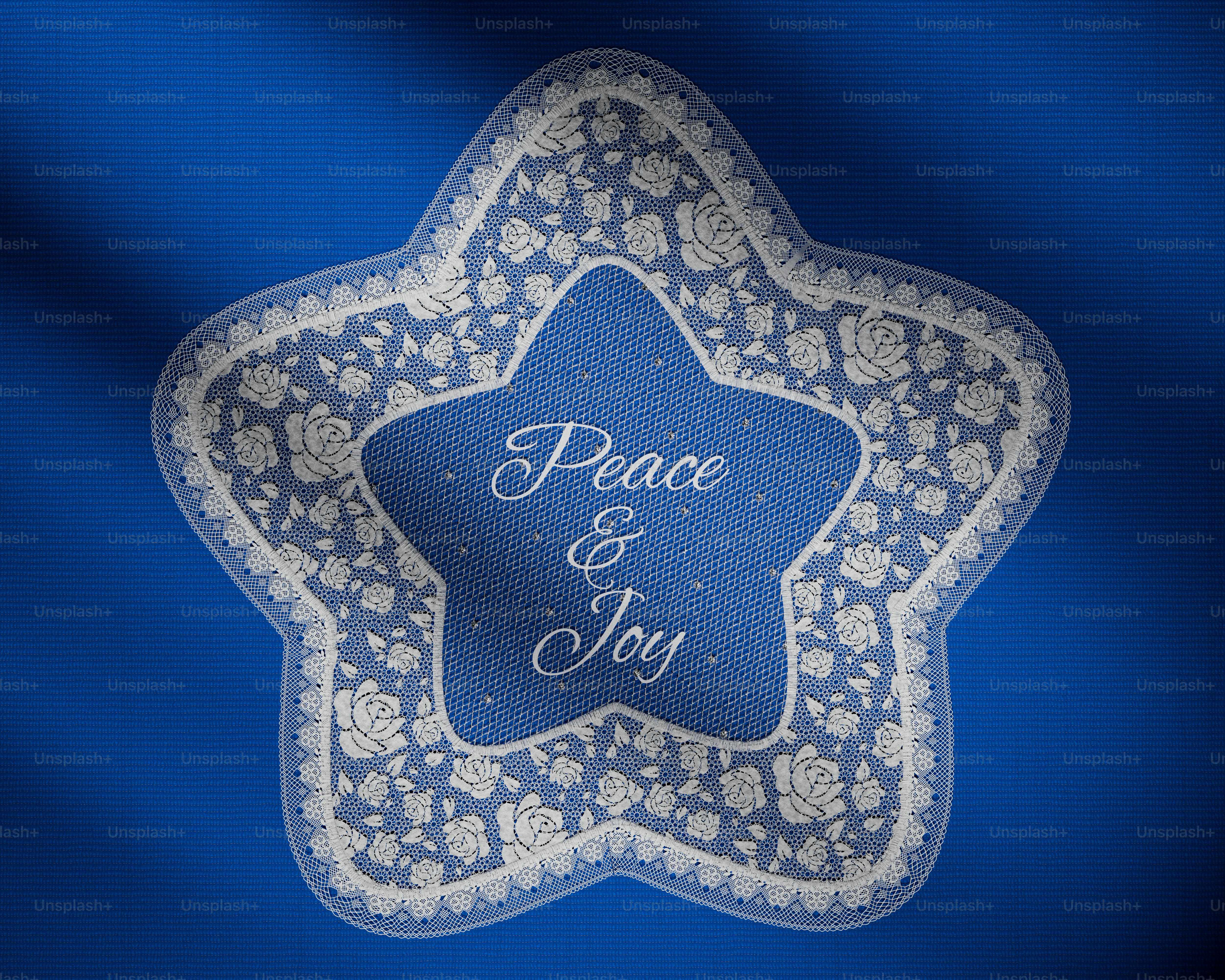 White lace star on blue fabric - Photo on Unsplash+