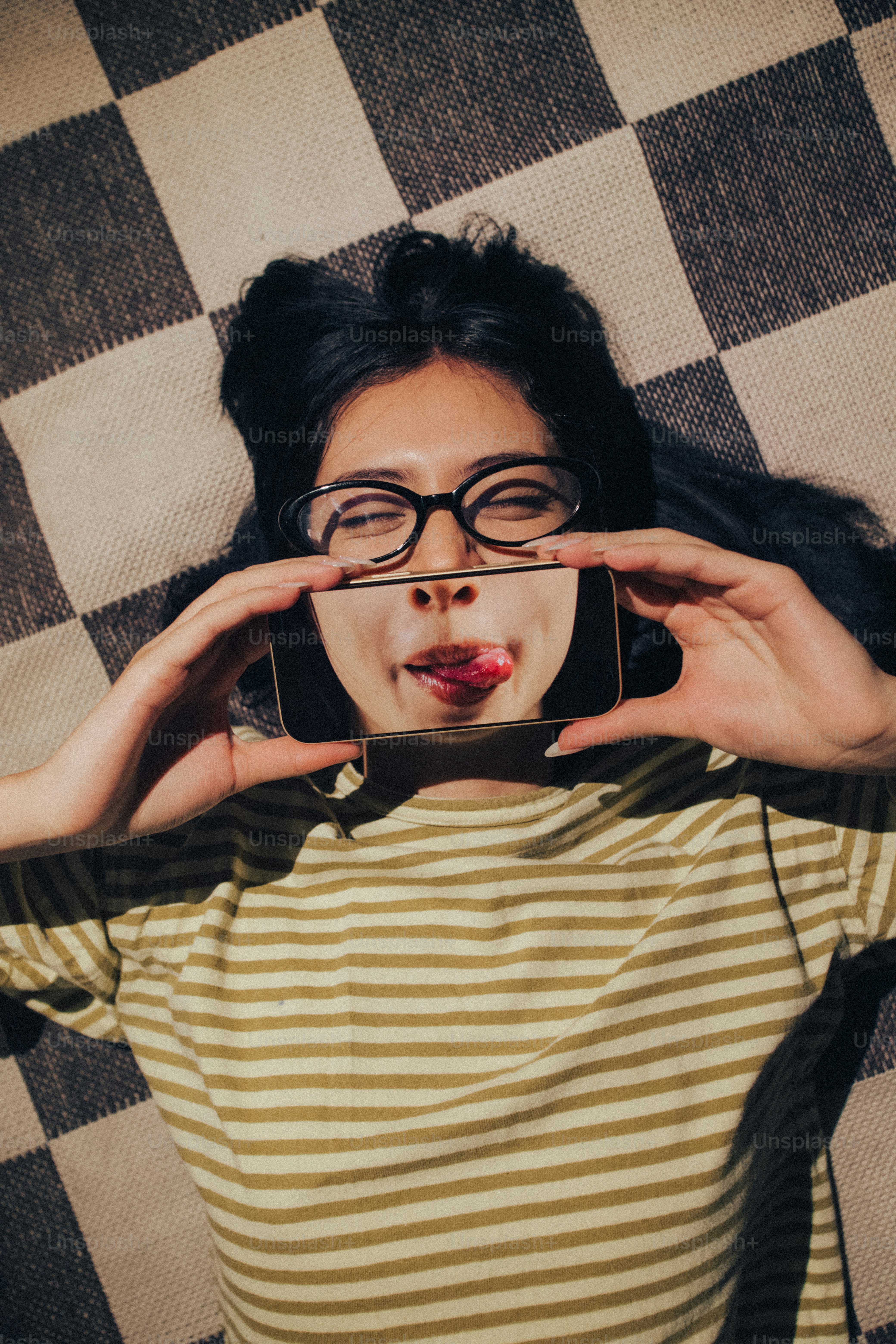 Smartphones displaying face halves - Photo on Unsplash+