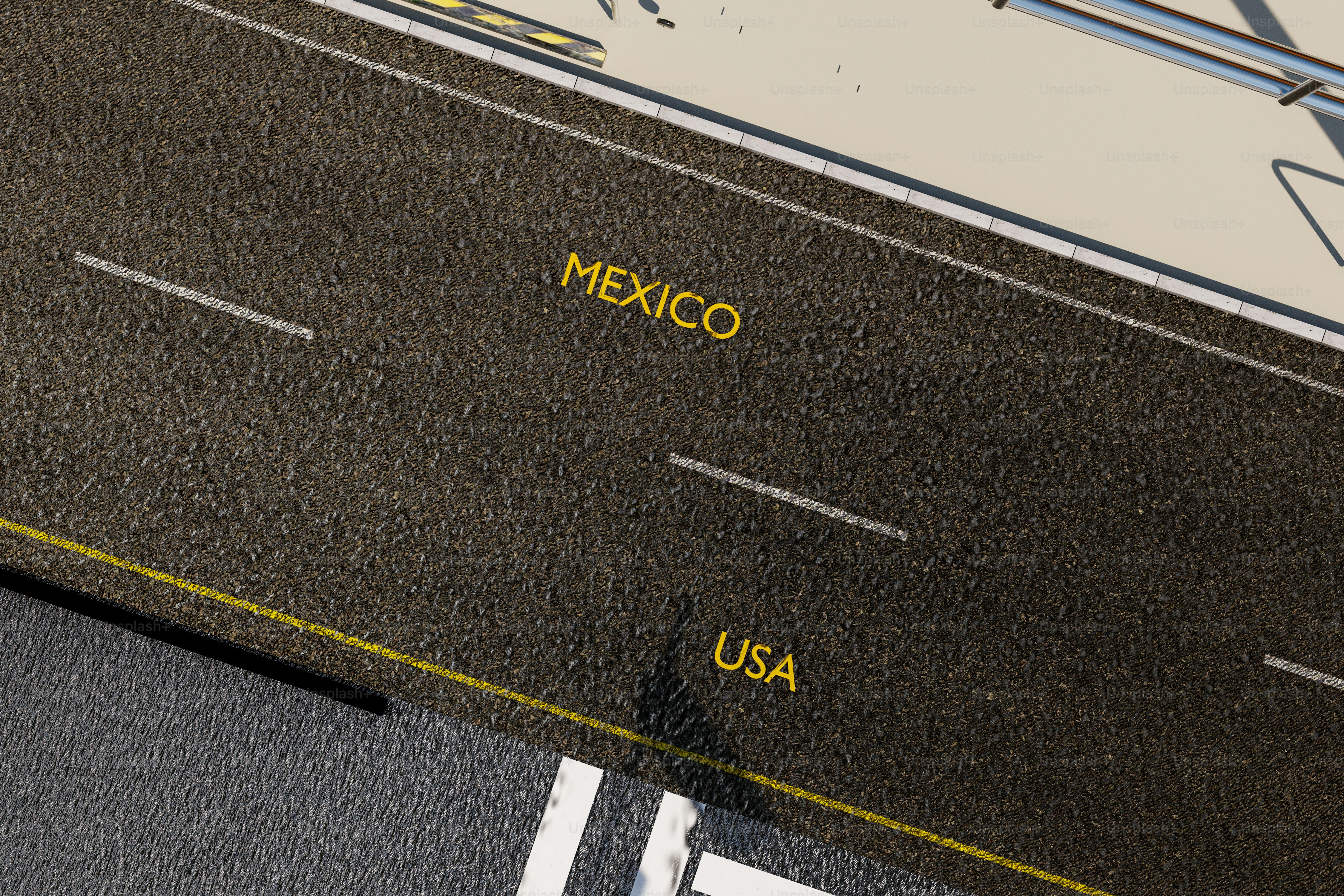 Mexican flag behind metal border fence - Photo on Unsplash+