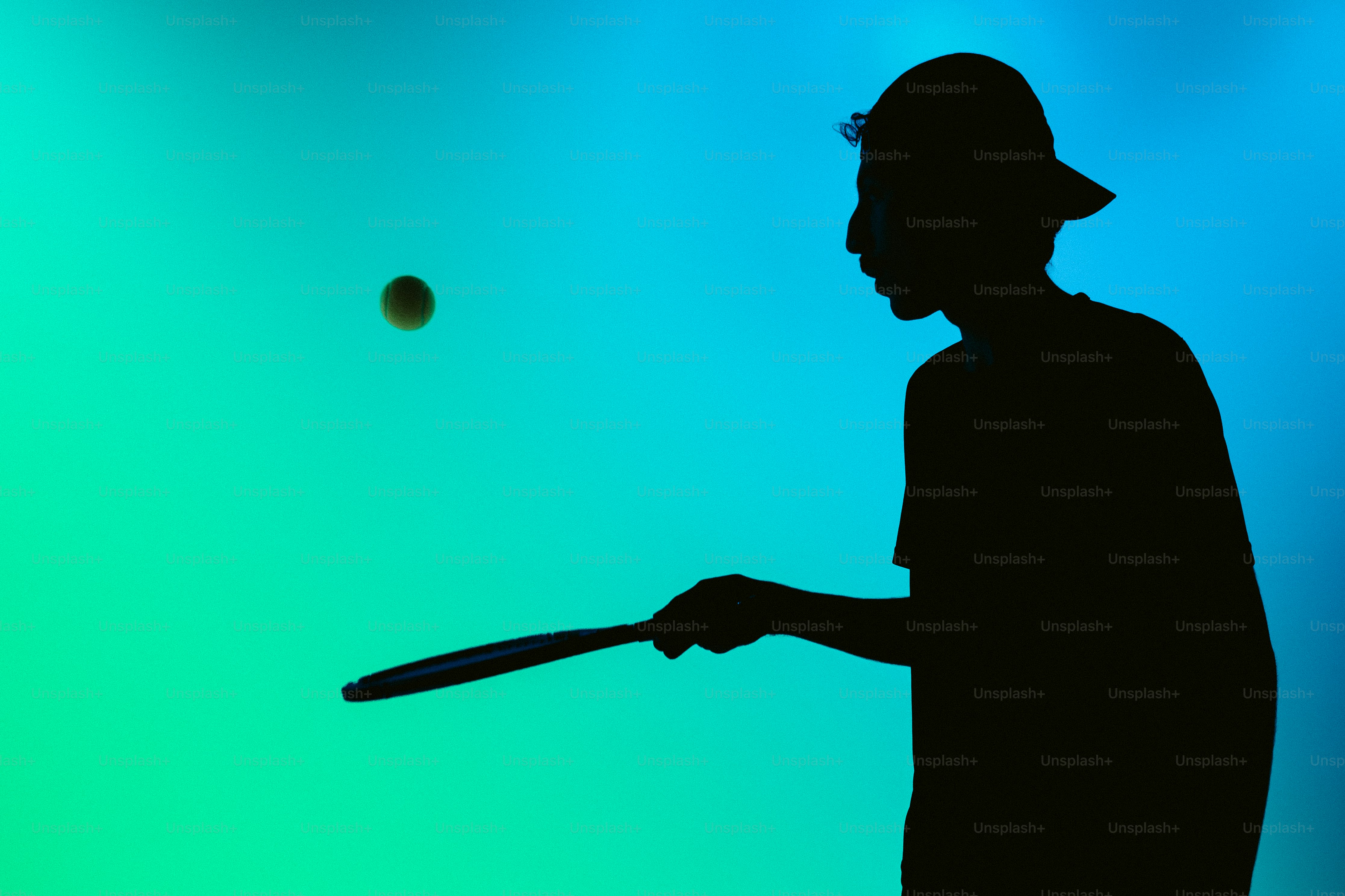 Person in silhouette playing racket sport - Photo on Unsplash+