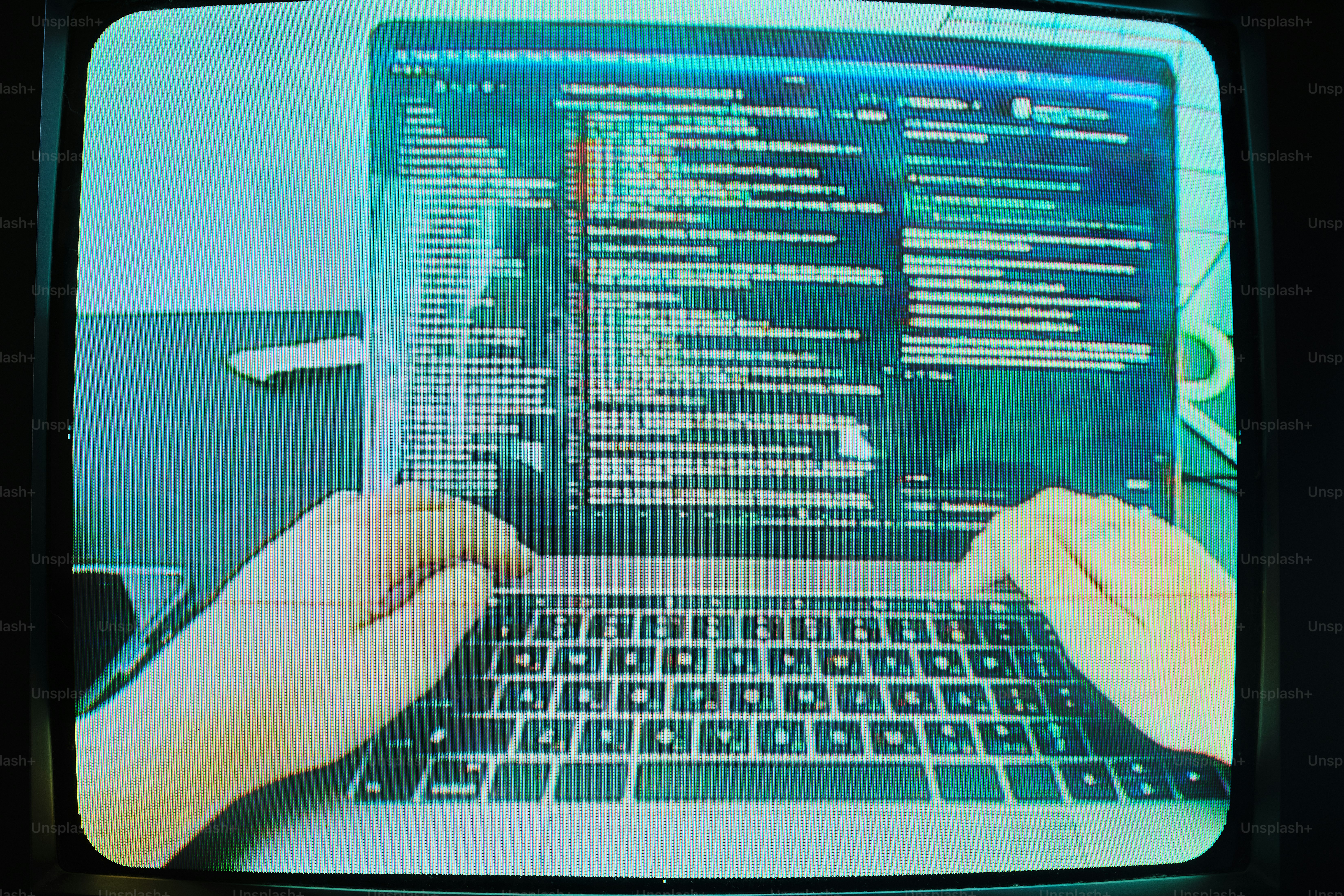 Hands typing code on laptop screen - Photo on Unsplash+