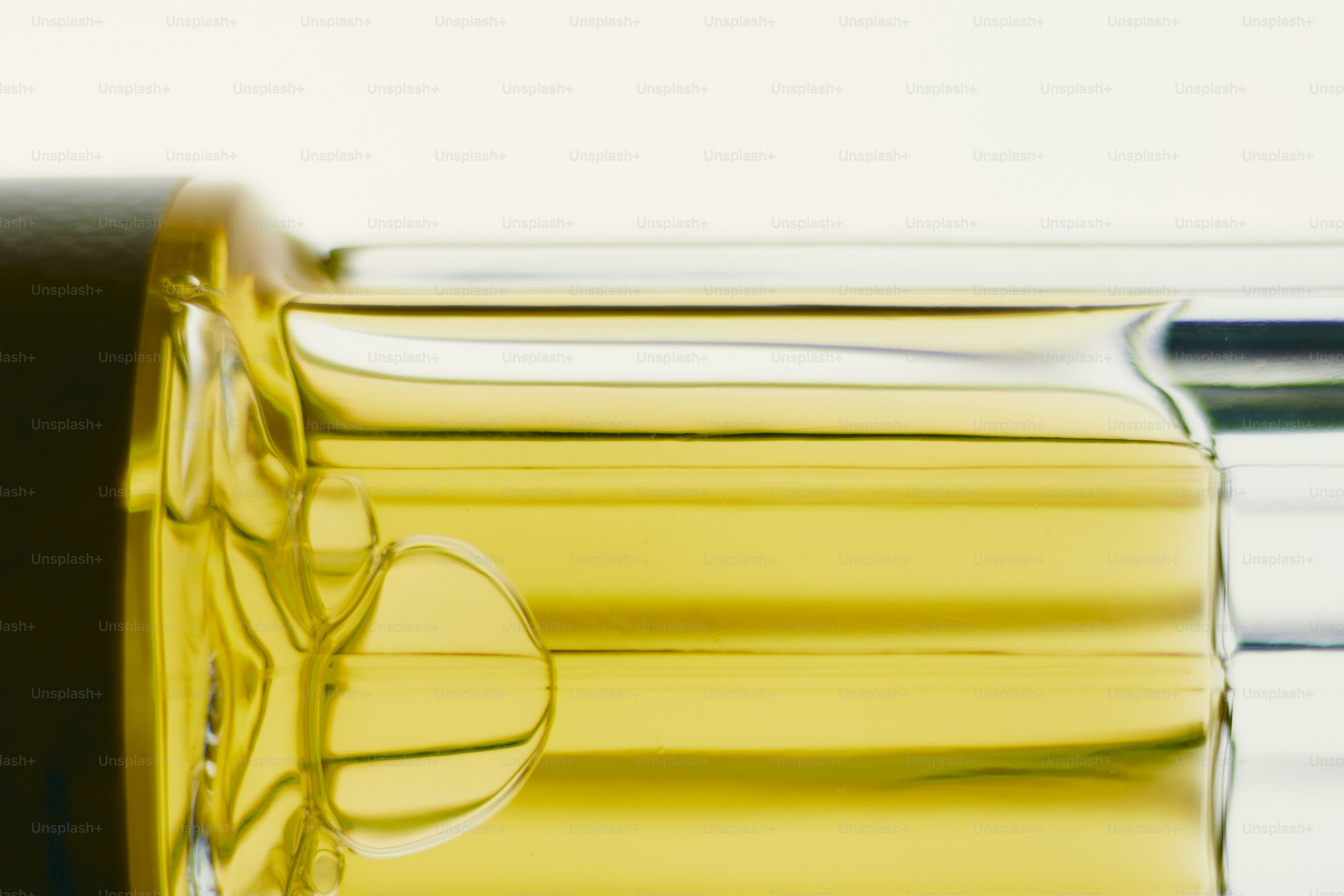 Amber liquid in glass bottle - Photo on Unsplash+