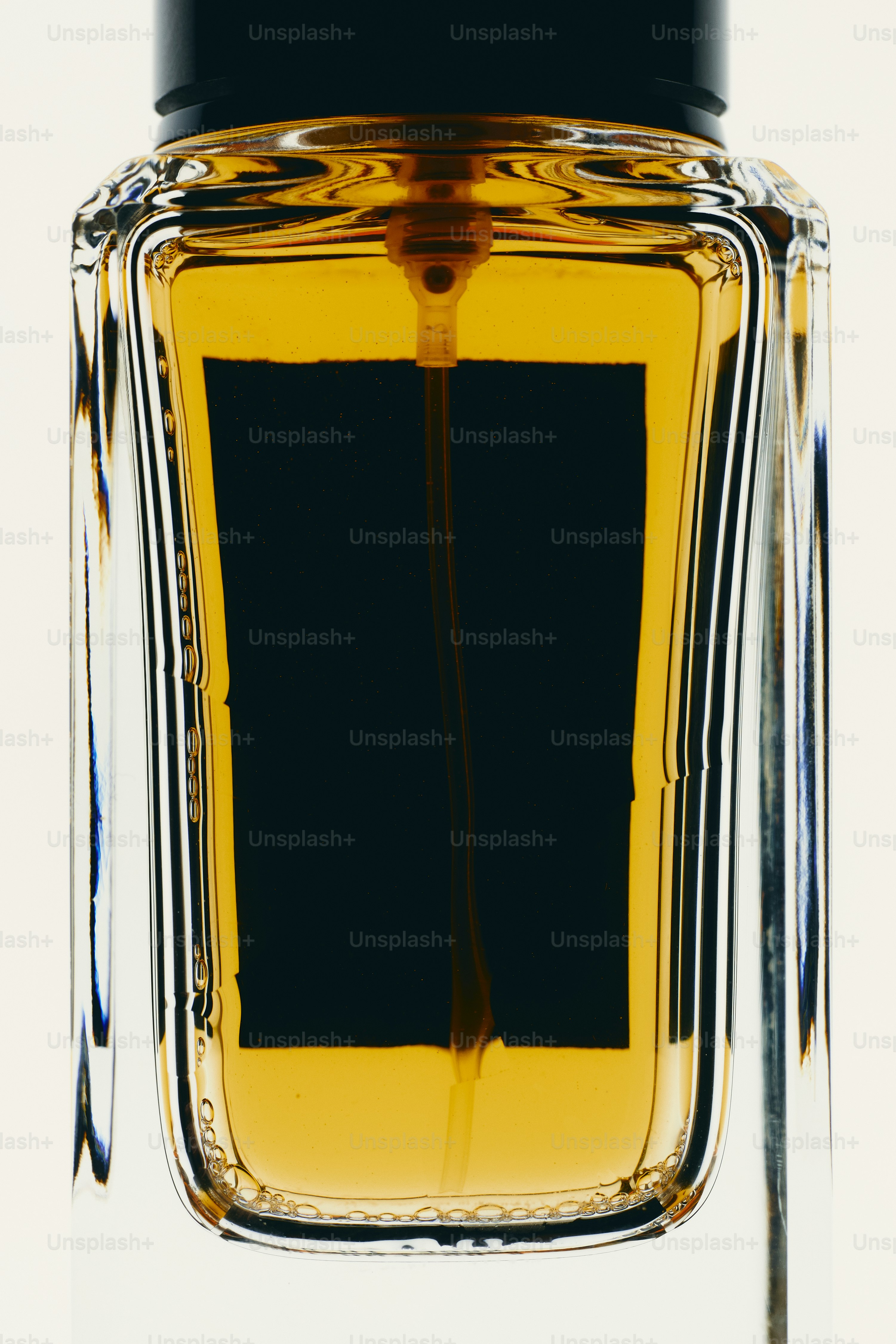 Amber liquid in glass bottle - Photo on Unsplash+