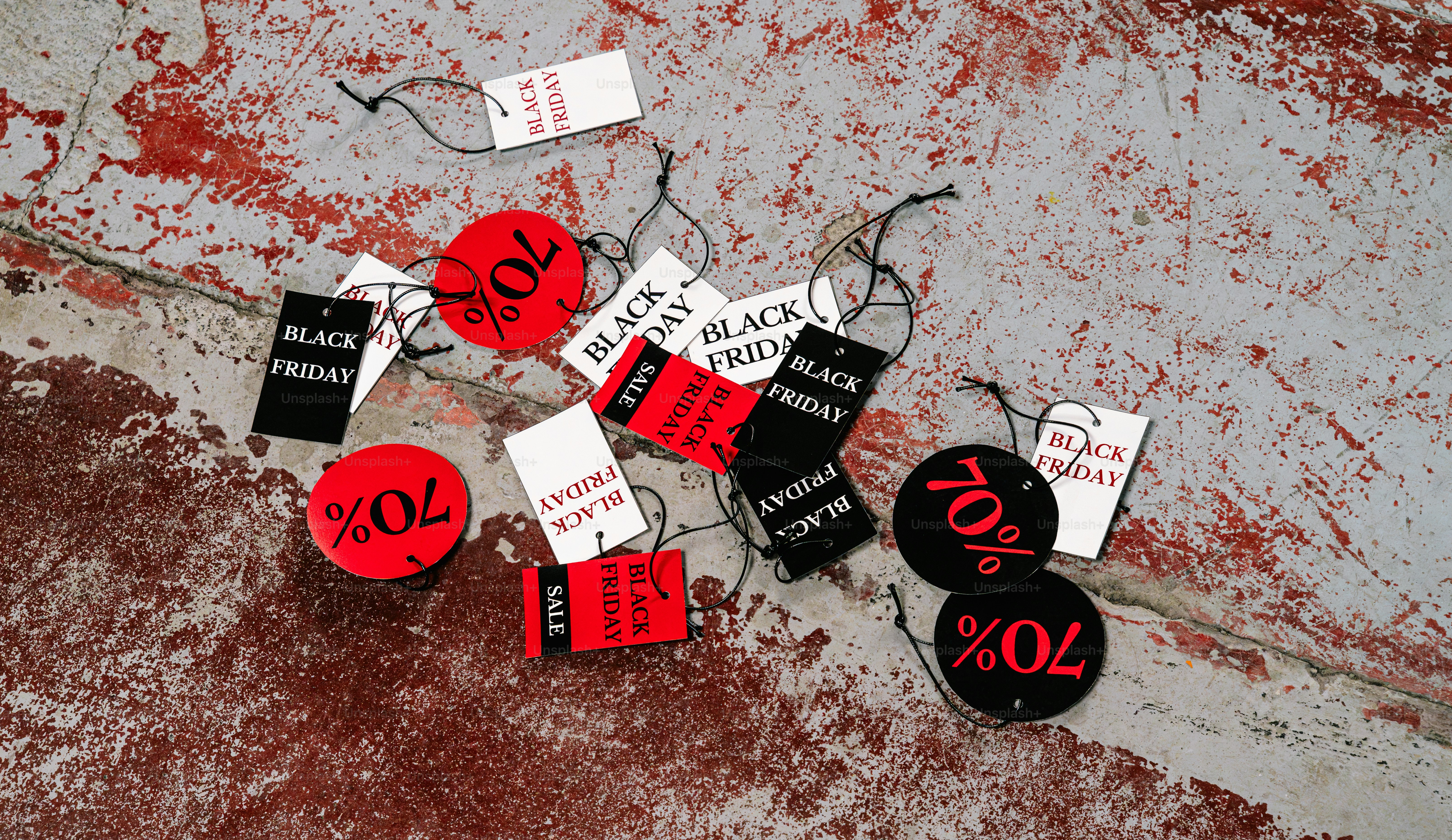 Black Friday sale tags on concrete - Photo on Unsplash+