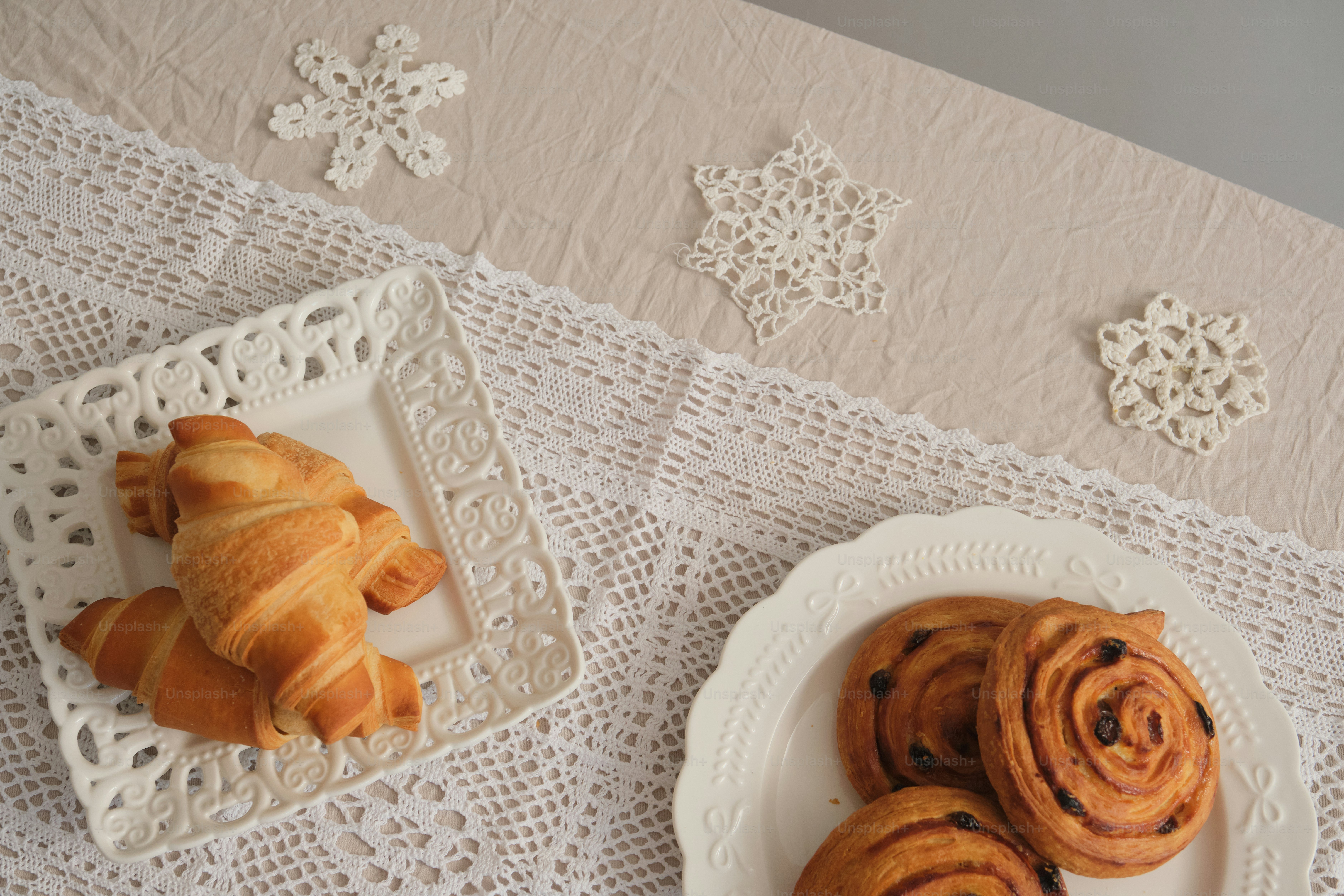 Citrus fruits and lace on tablecloth - Photo on Unsplash+
