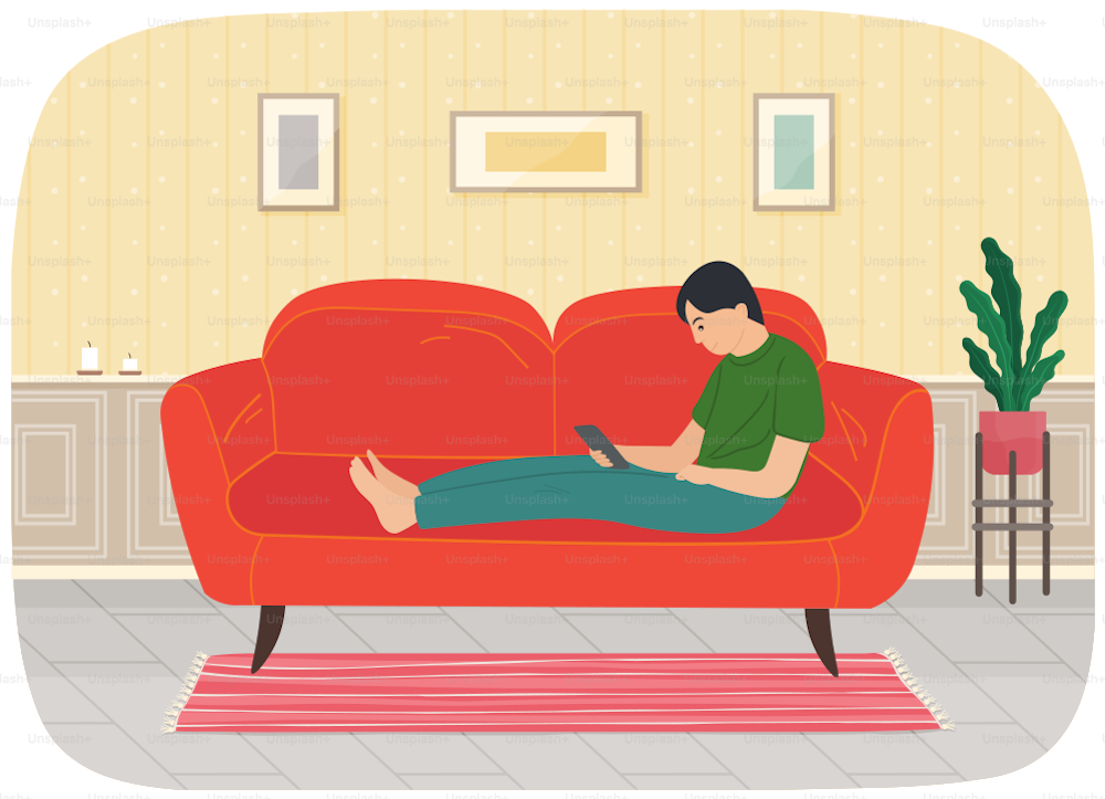 Young man sitting on sofa with tablet pc, working at home with electronic equipment in his hands. Male character studying remotely, watches social media, serfing Internet. Person doing homework