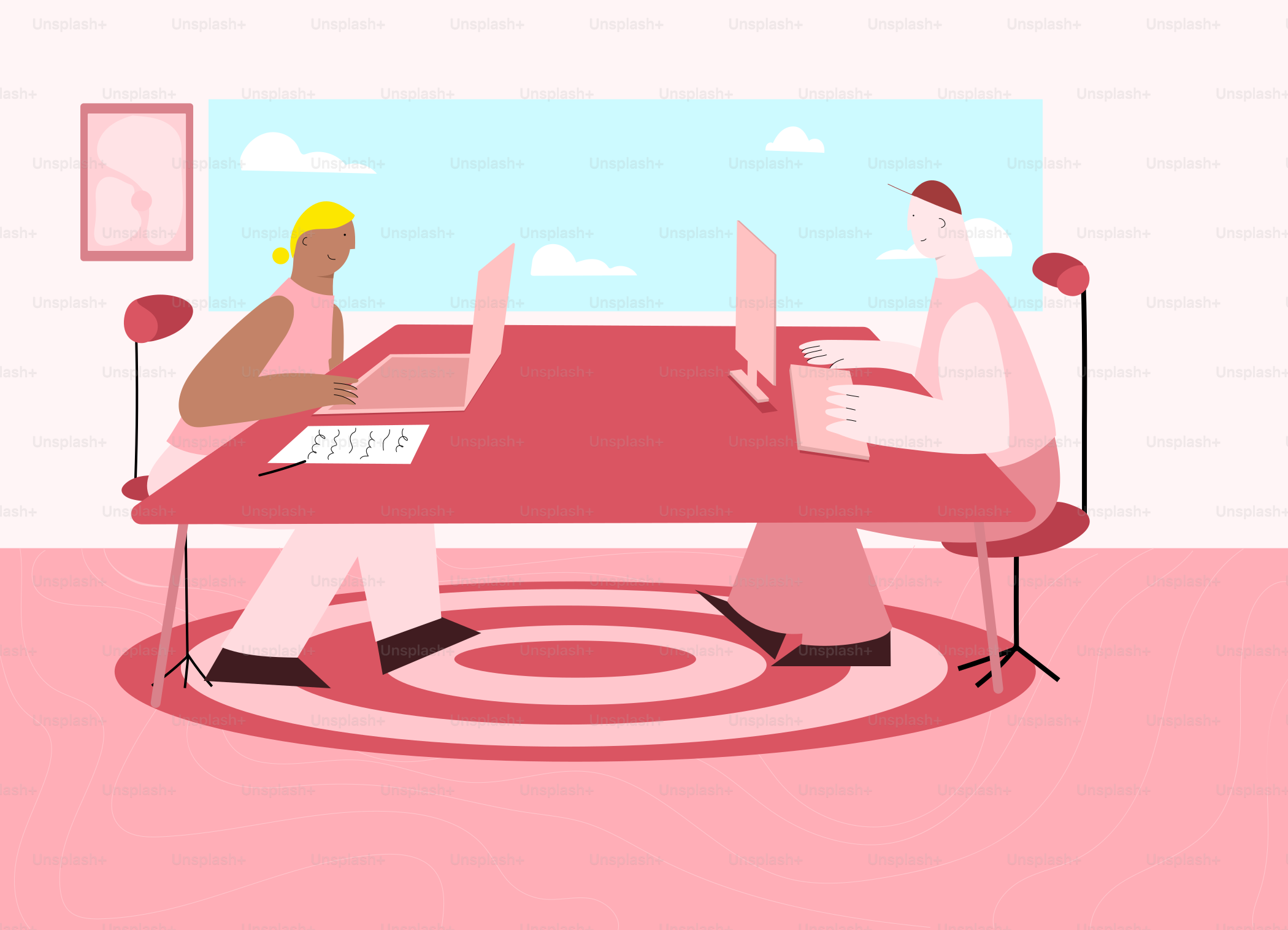 Two people working on laptops at a large table.