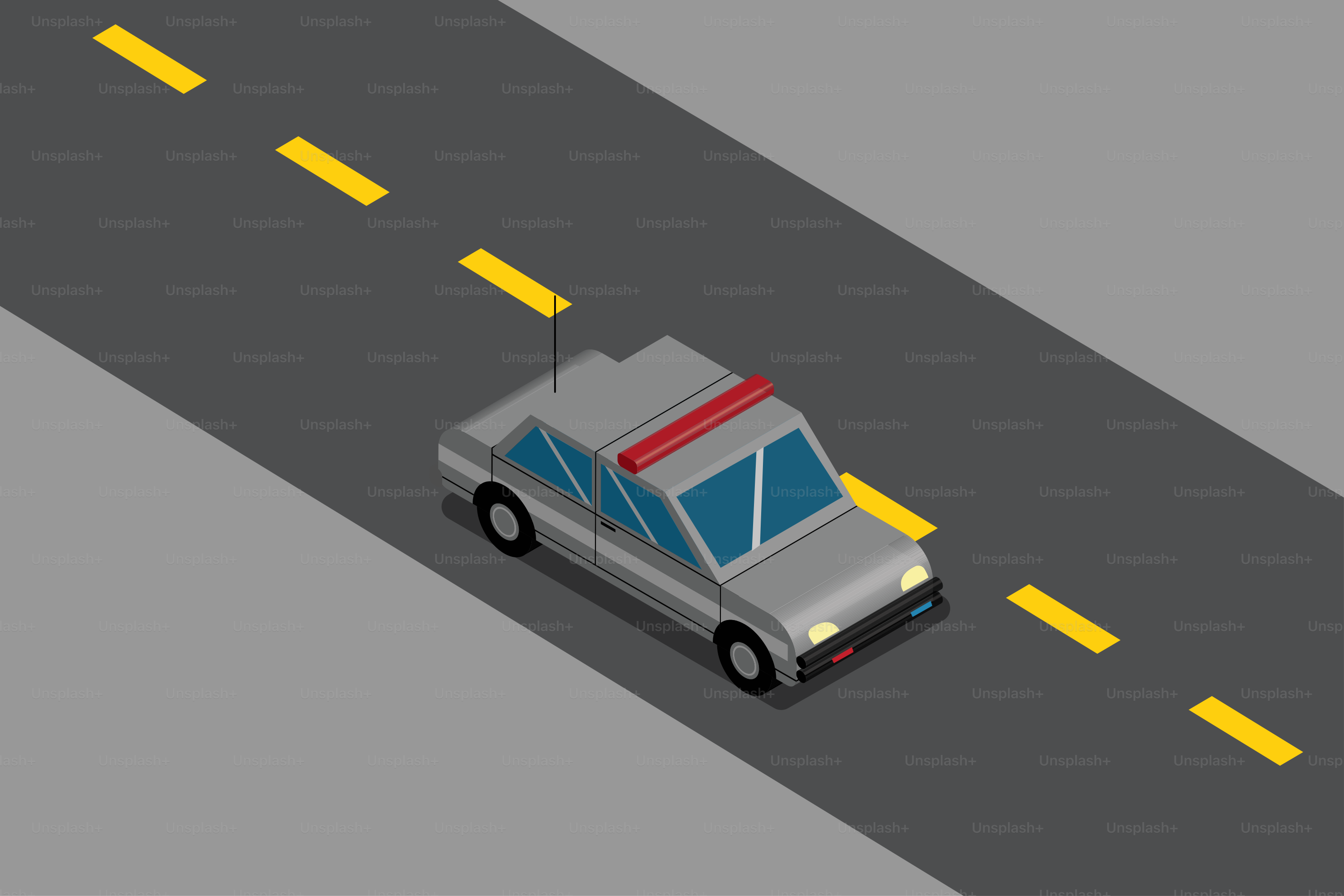 A silver police car drives on a road.