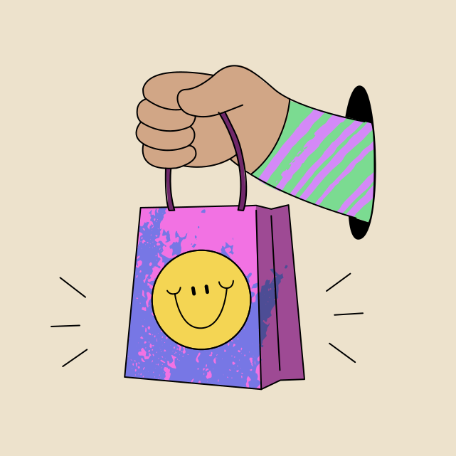 웃는 얼굴이 그려진 쇼핑백을 들고 있는 손