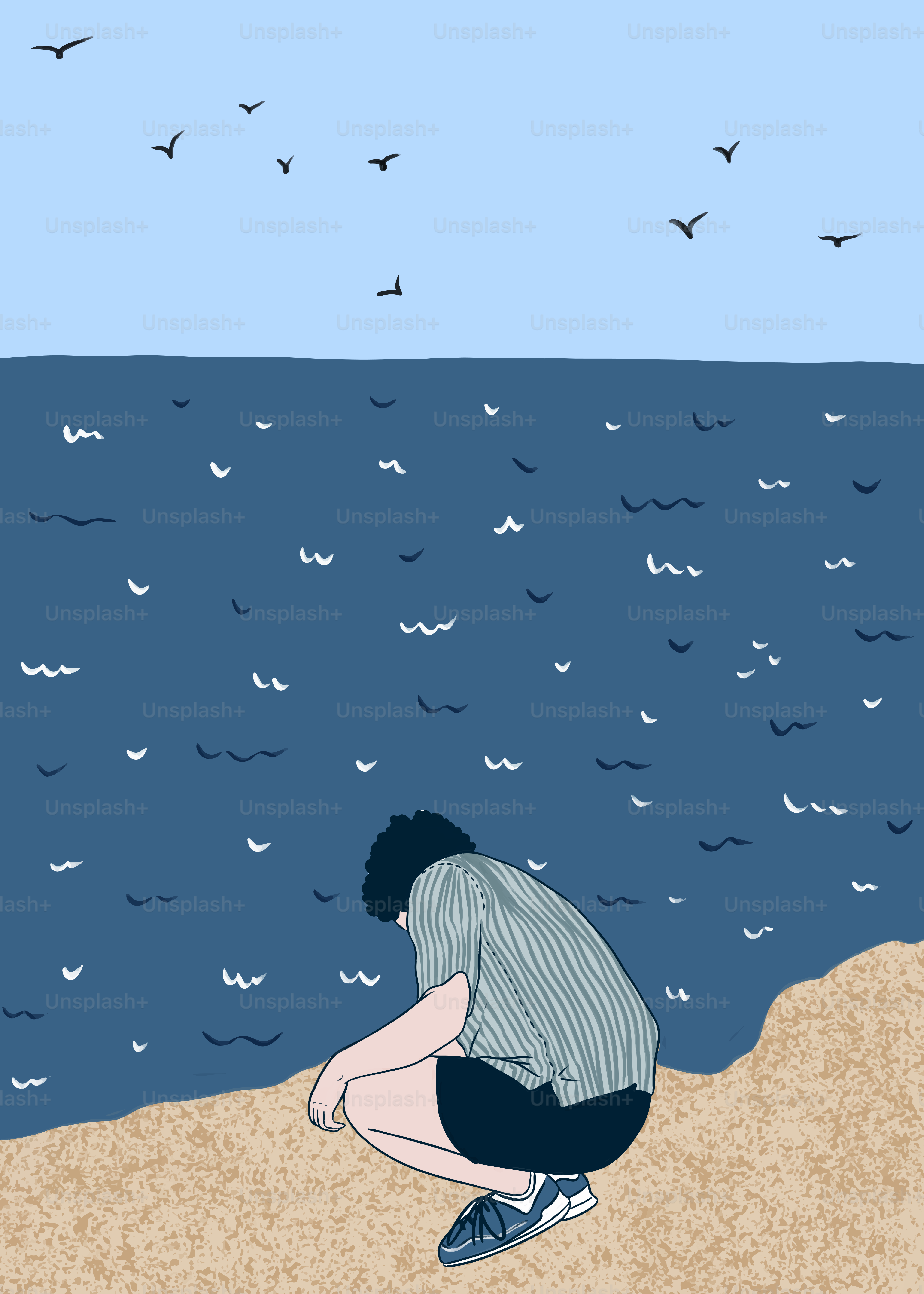 A man sitting on a beach next to the ocean