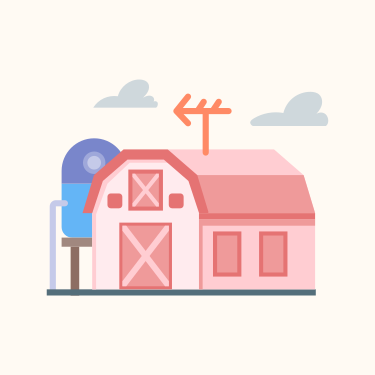 Une grange rose au toit rouge à côté d’une boîte aux lettres bleue