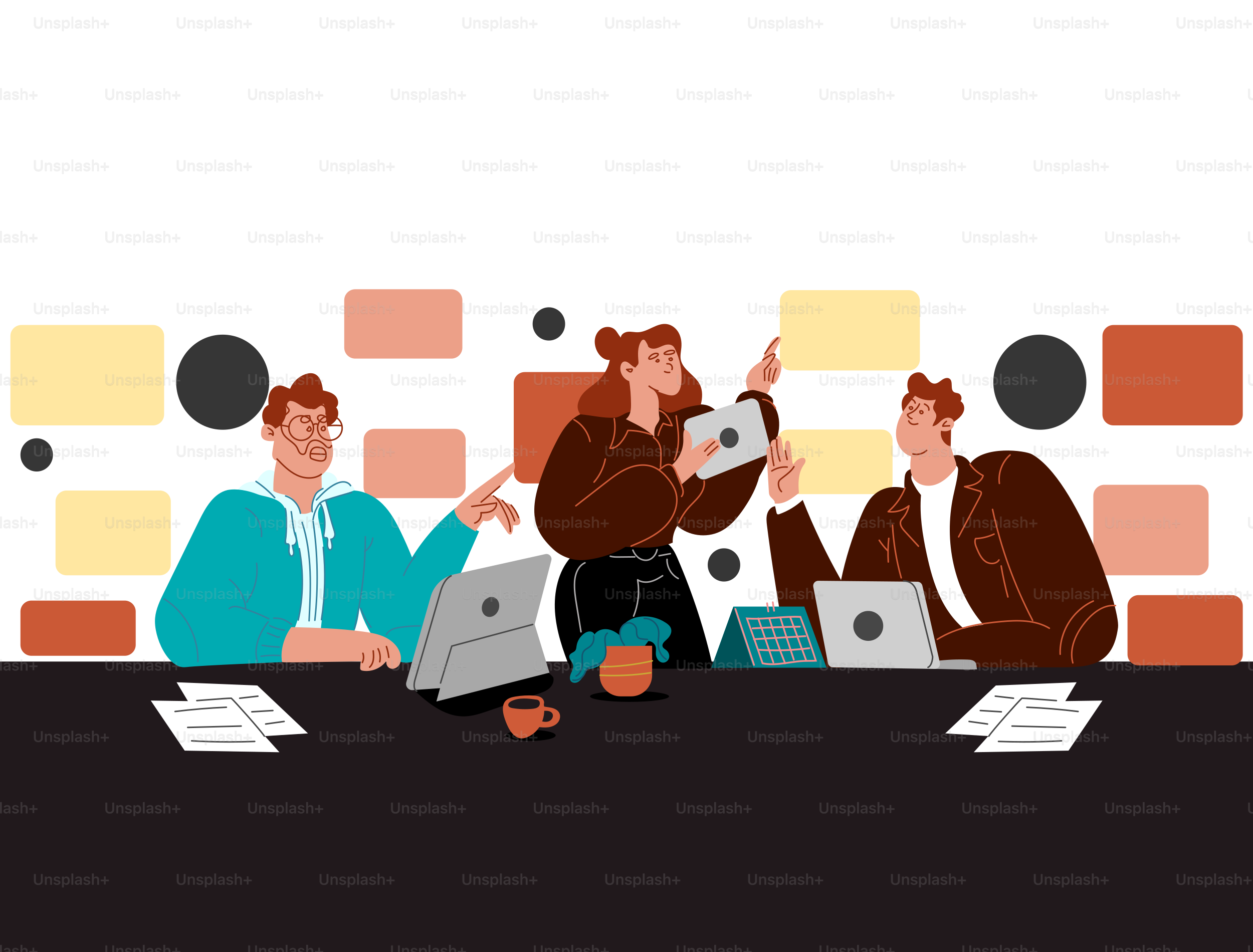 A group of people sitting around a table with laptops
