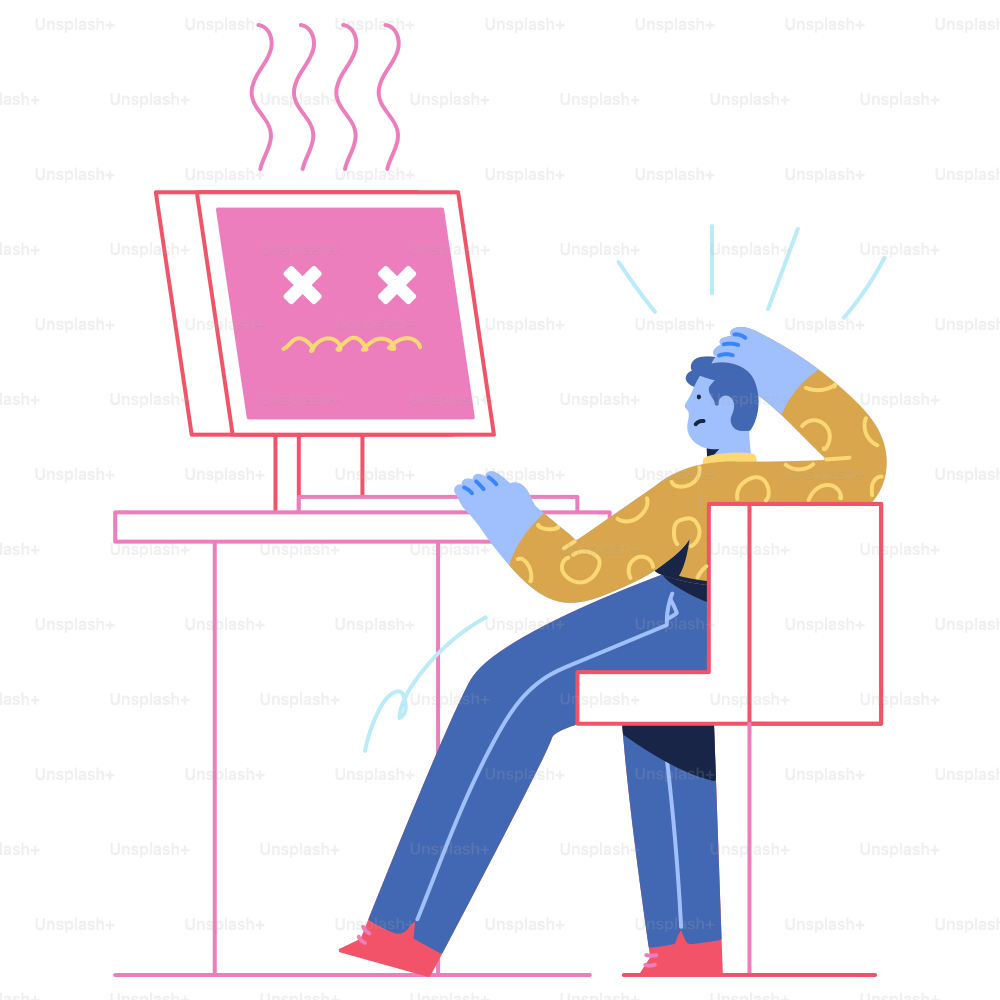 机に座ってパソコンをしている男