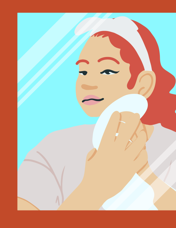 A woman brushing her hair in front of a mirror