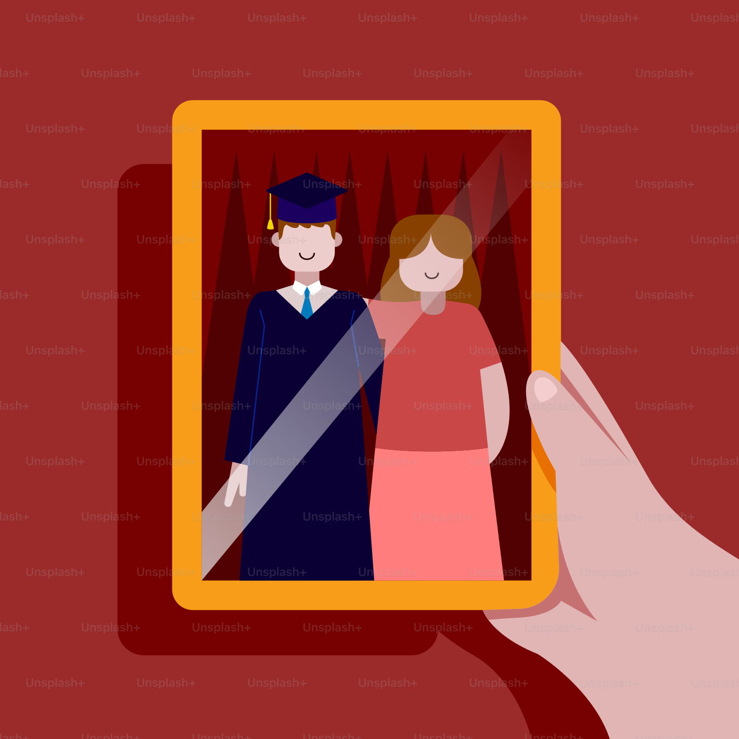 A hand holding a picture of a graduate and a woman