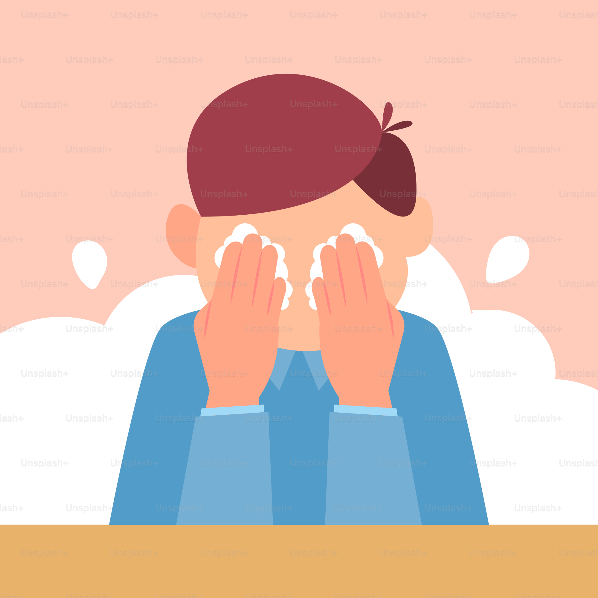 A person sitting at a table with their hands covering their face