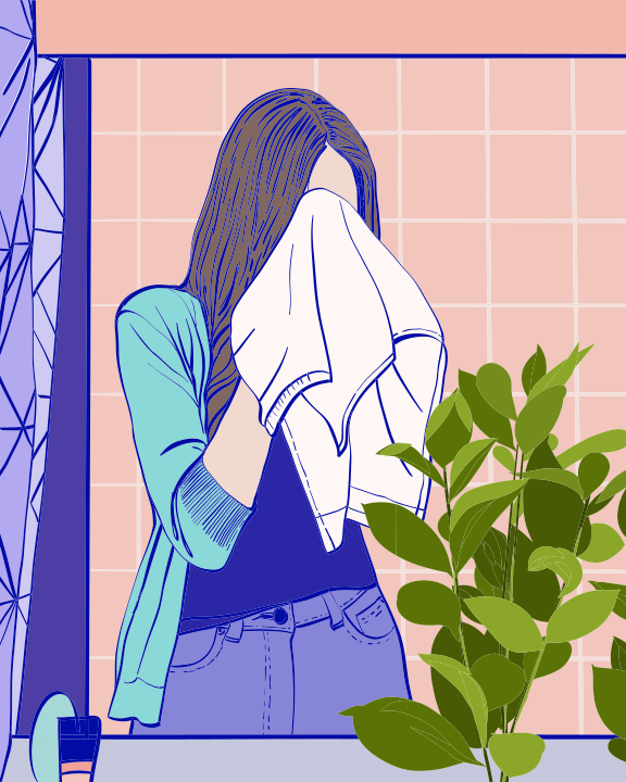 A woman wiping her face in front of a mirror