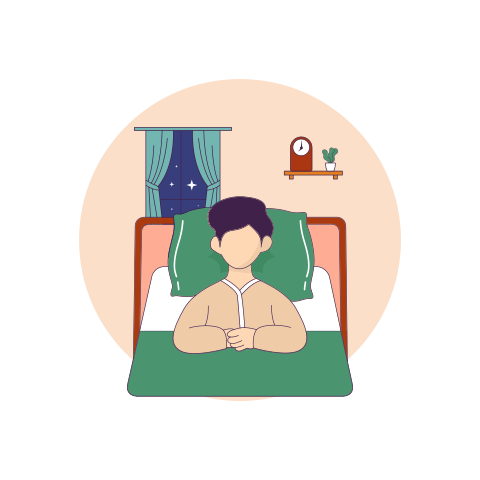 A man laying in bed with a night stand next to him