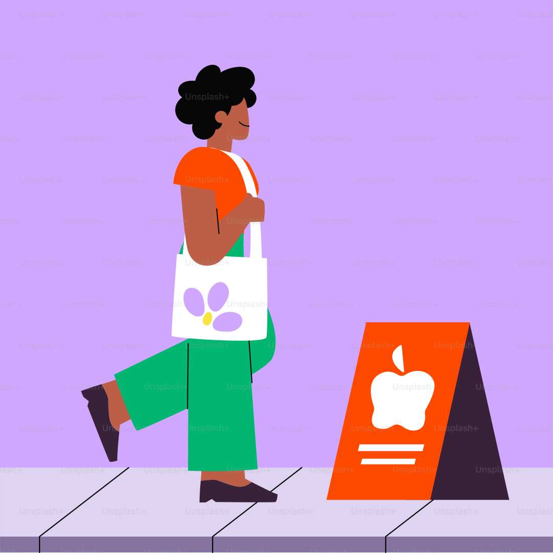 A woman walking past a sign with an apple on it