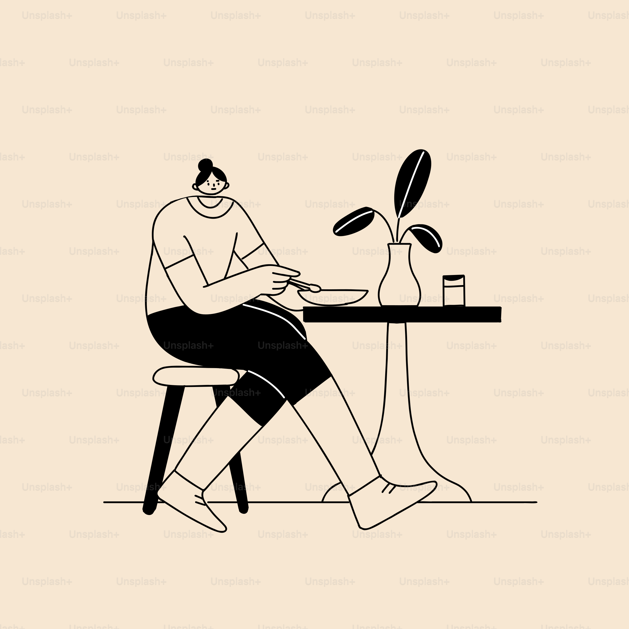 A person sitting at a table with a plant