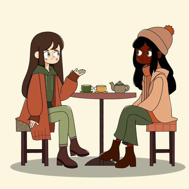 Un par de mujeres sentadas en una mesa