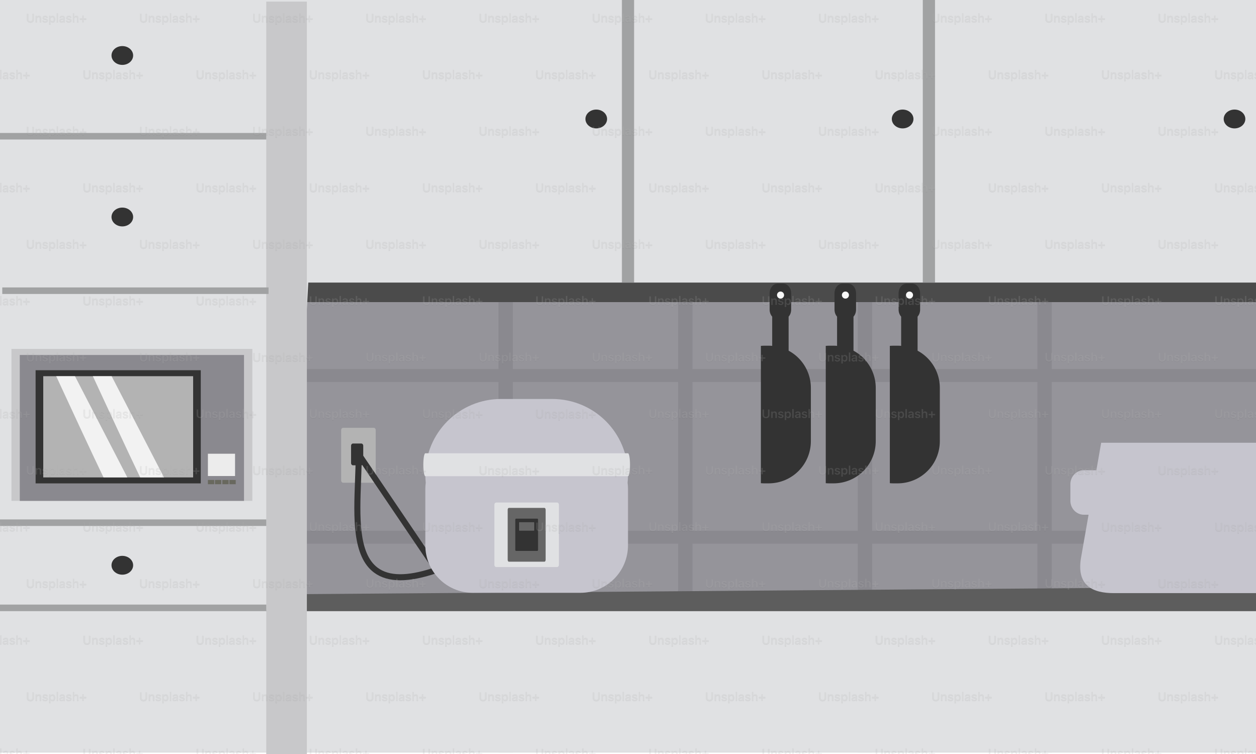 A kitchen with white cabinets and gray counter tops