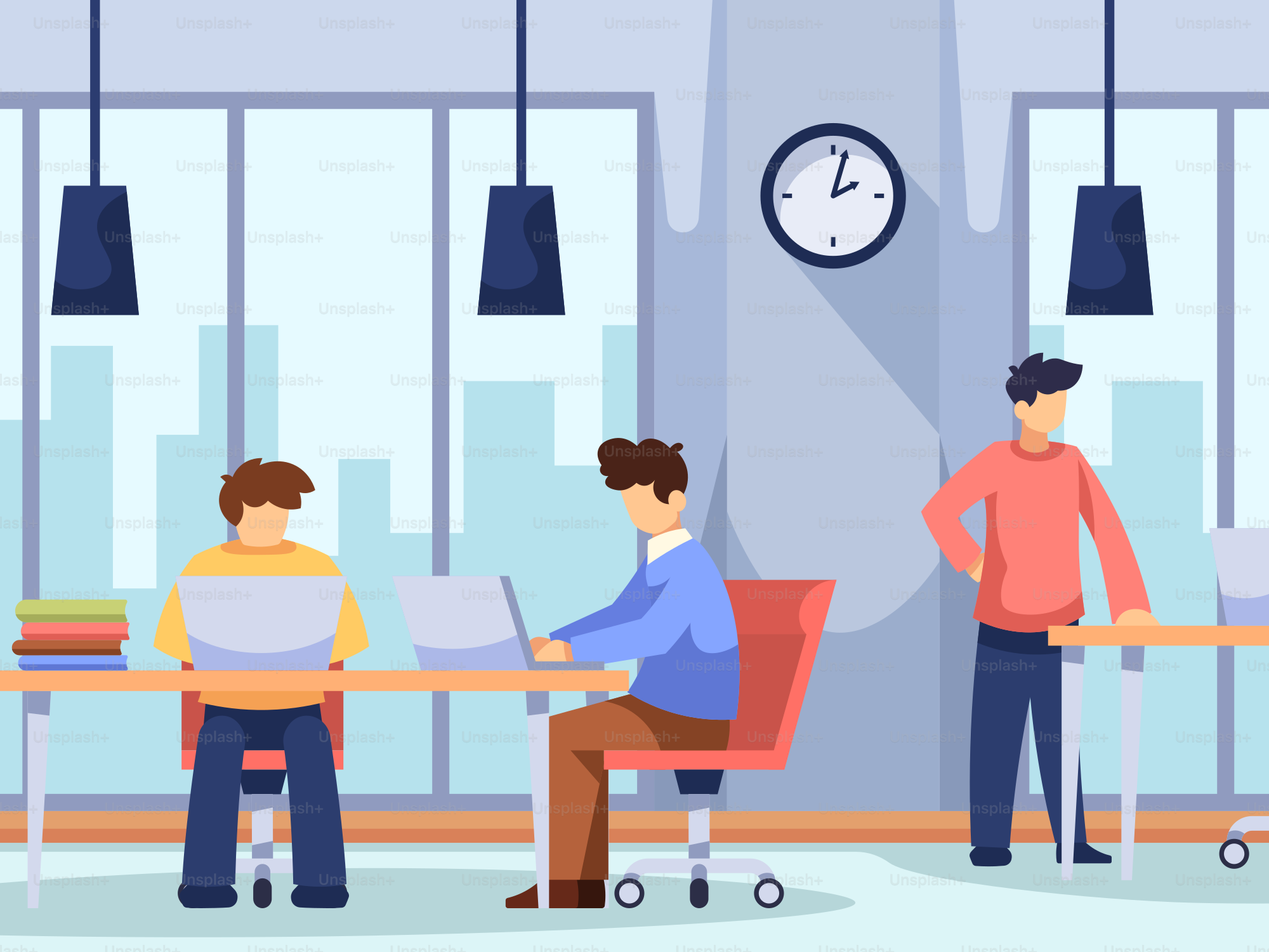 A group of people sitting at a table working on laptops