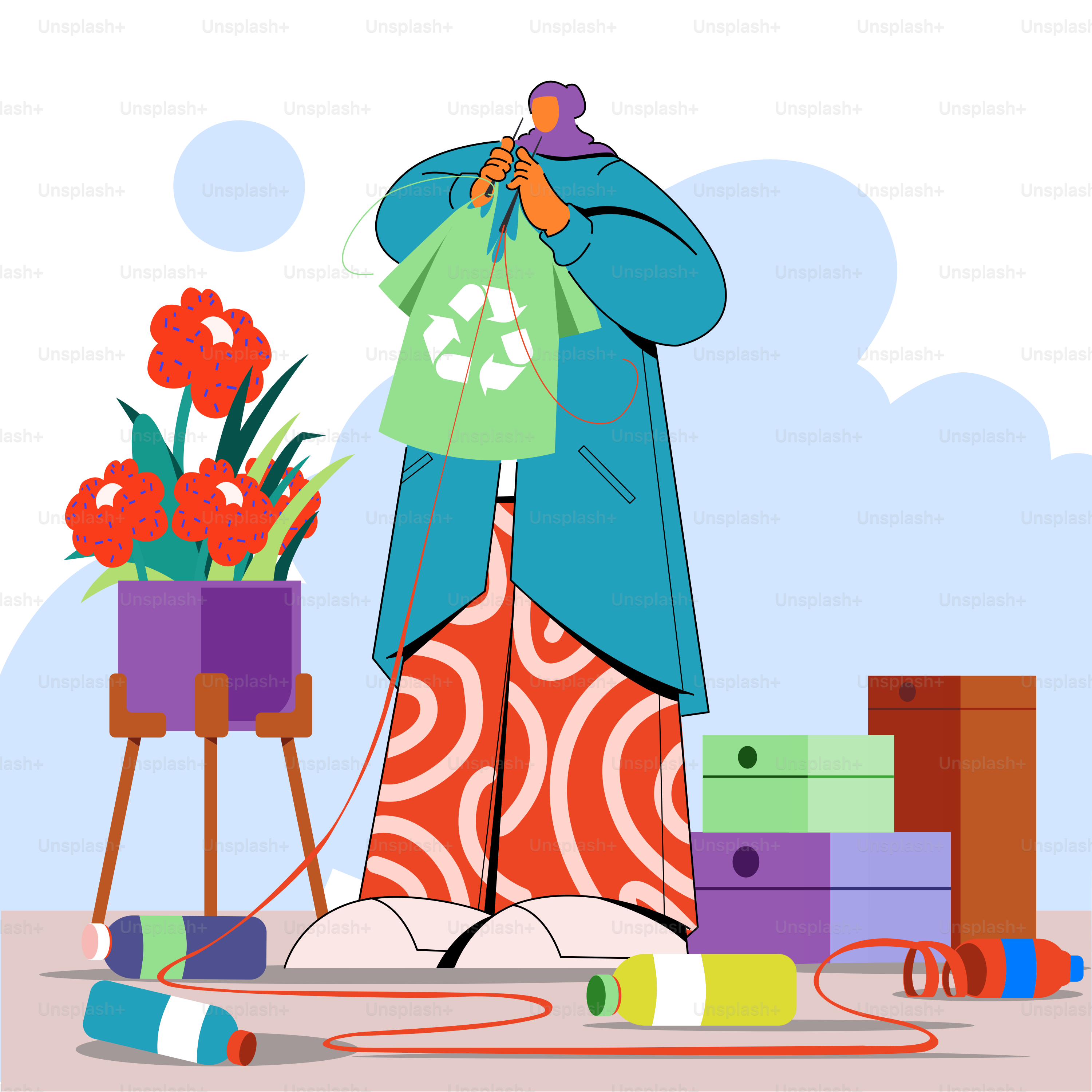 A woman holding a t - shirt in front of a pile of items