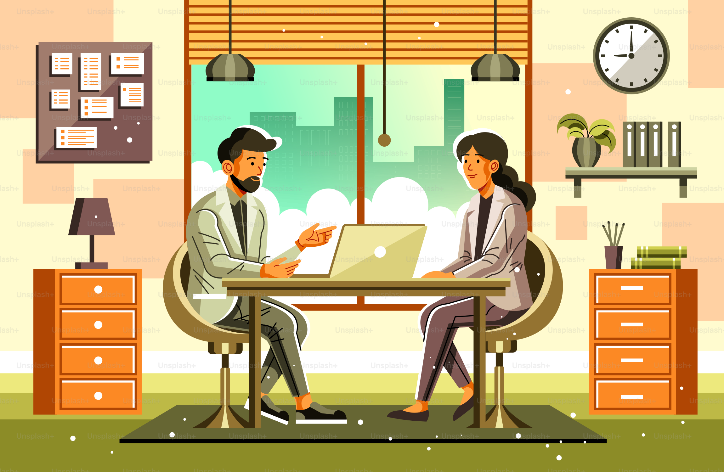 A man and woman sitting at a table in front of a laptop