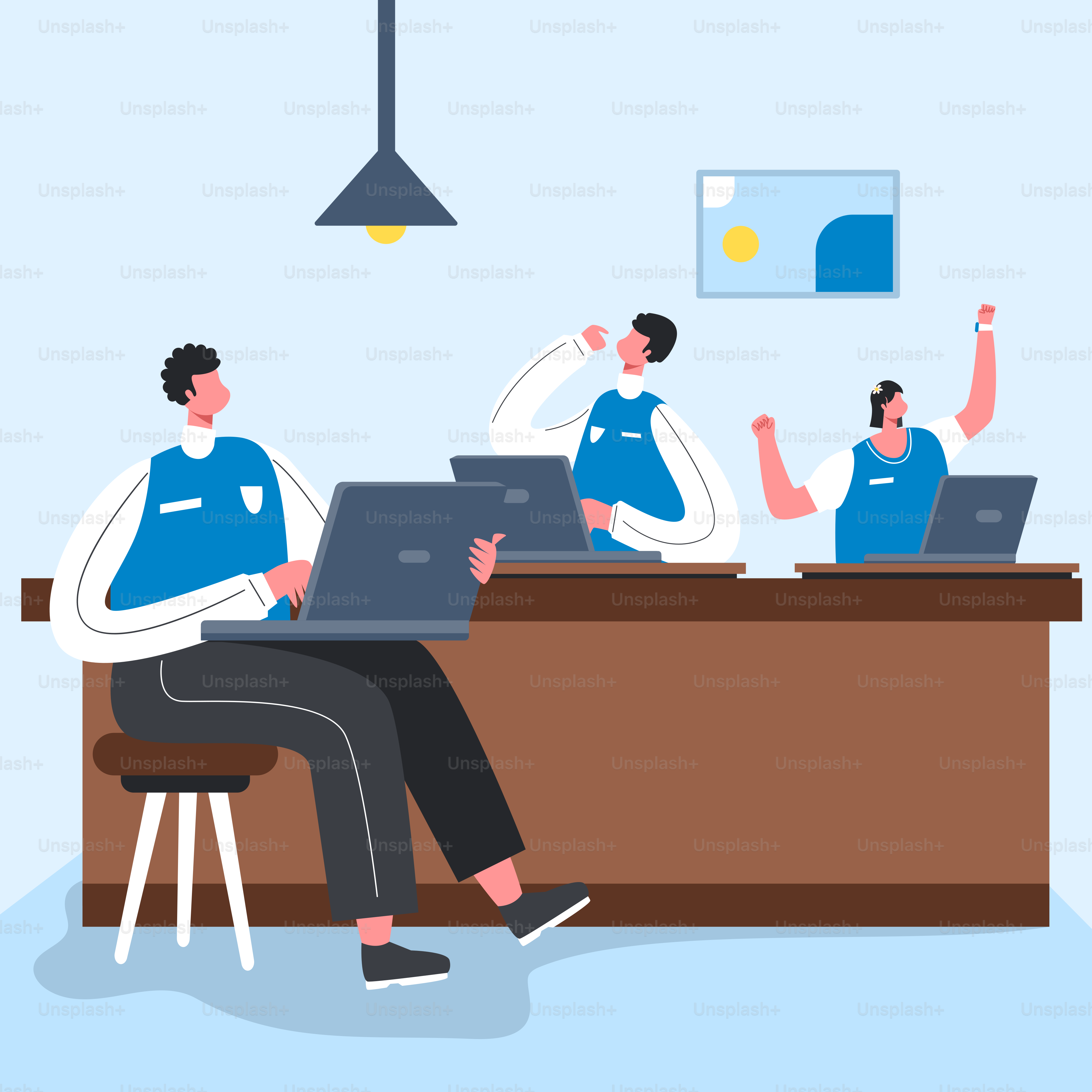 A group of people sitting at a table working on laptops