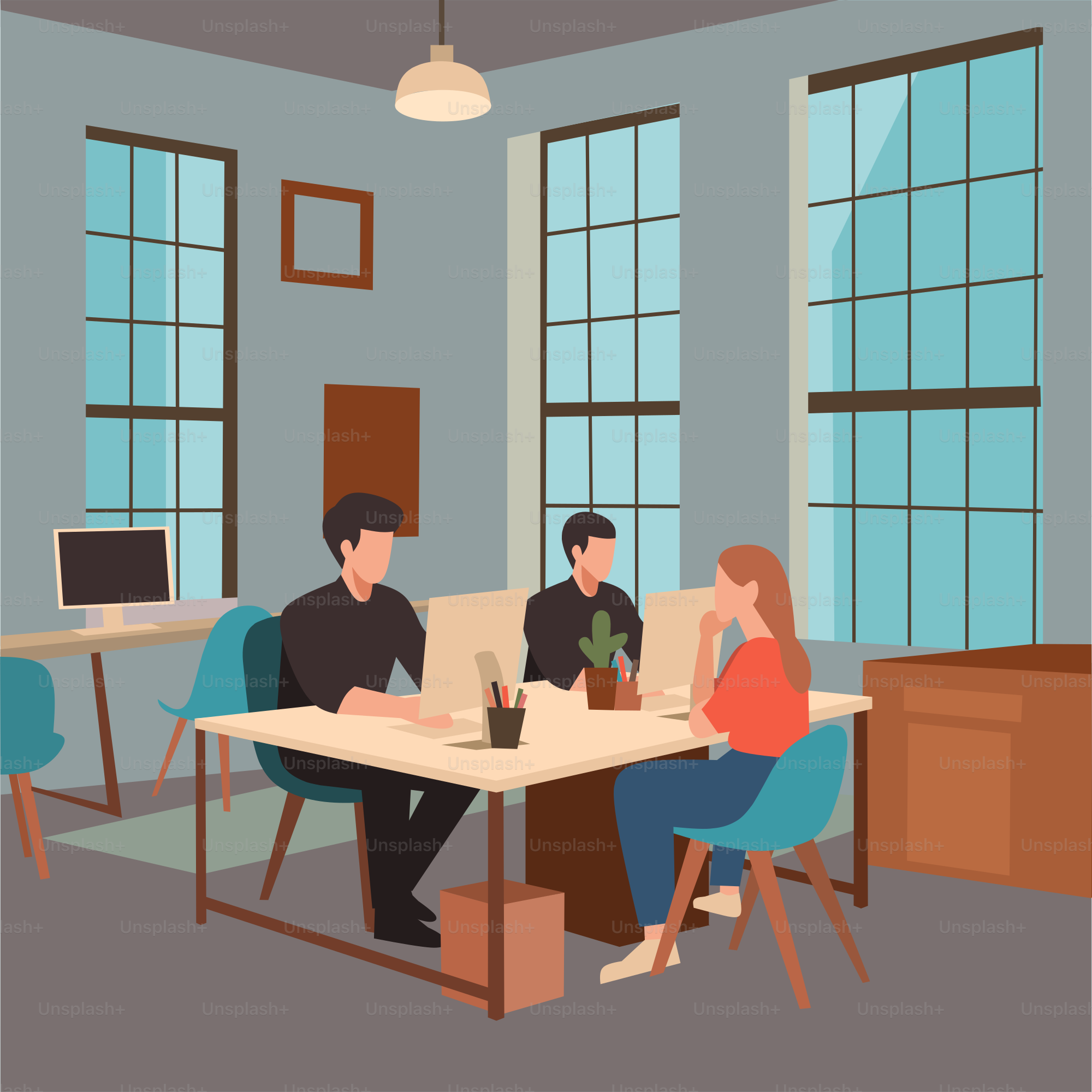 A group of people sitting at a table working on laptops