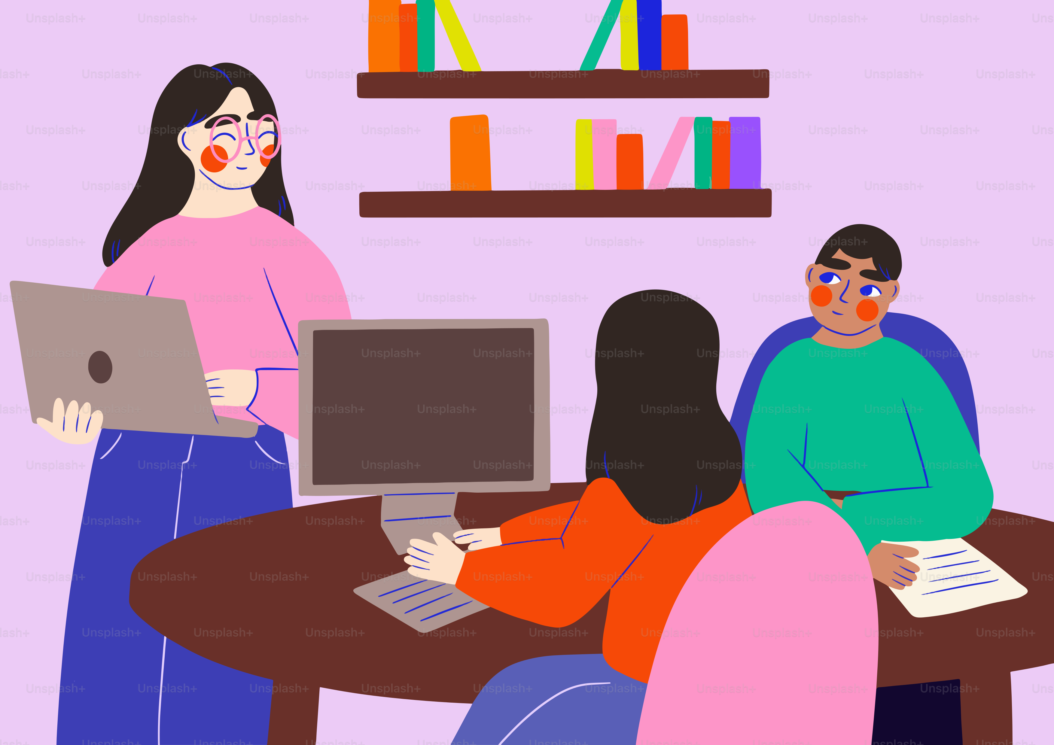 A group of people sitting around a table with laptops