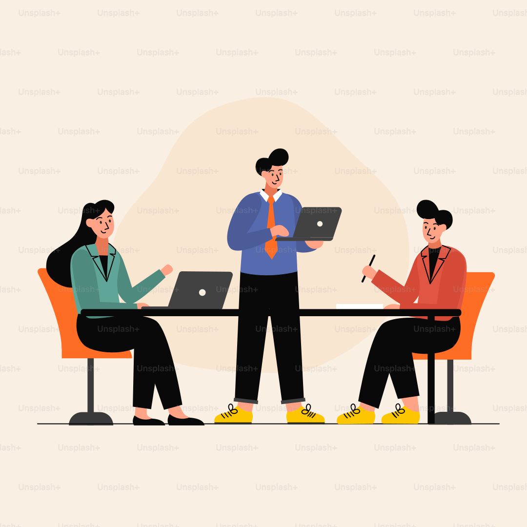 A group of people sitting around a table with laptops