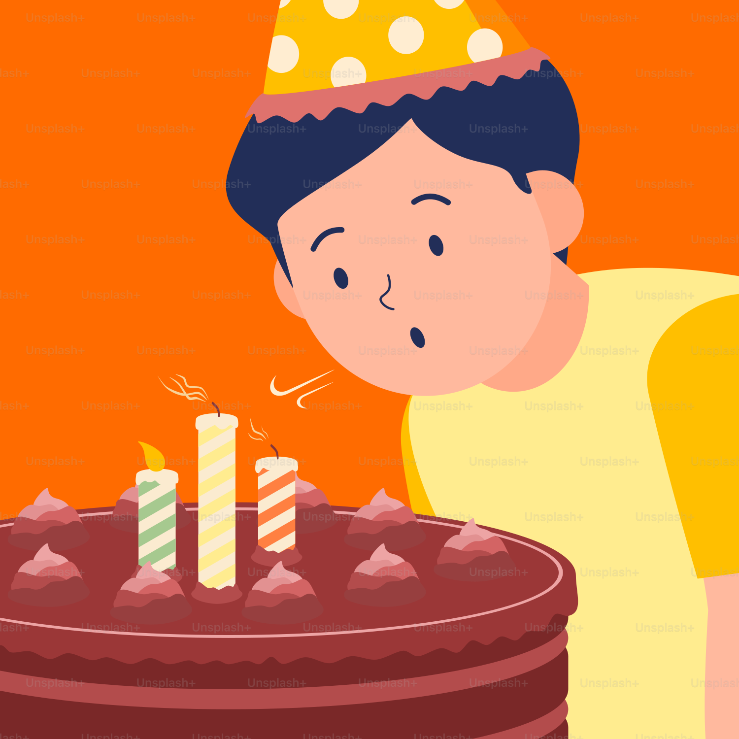 誕生日ケーキのろうそくを吹き消す少年