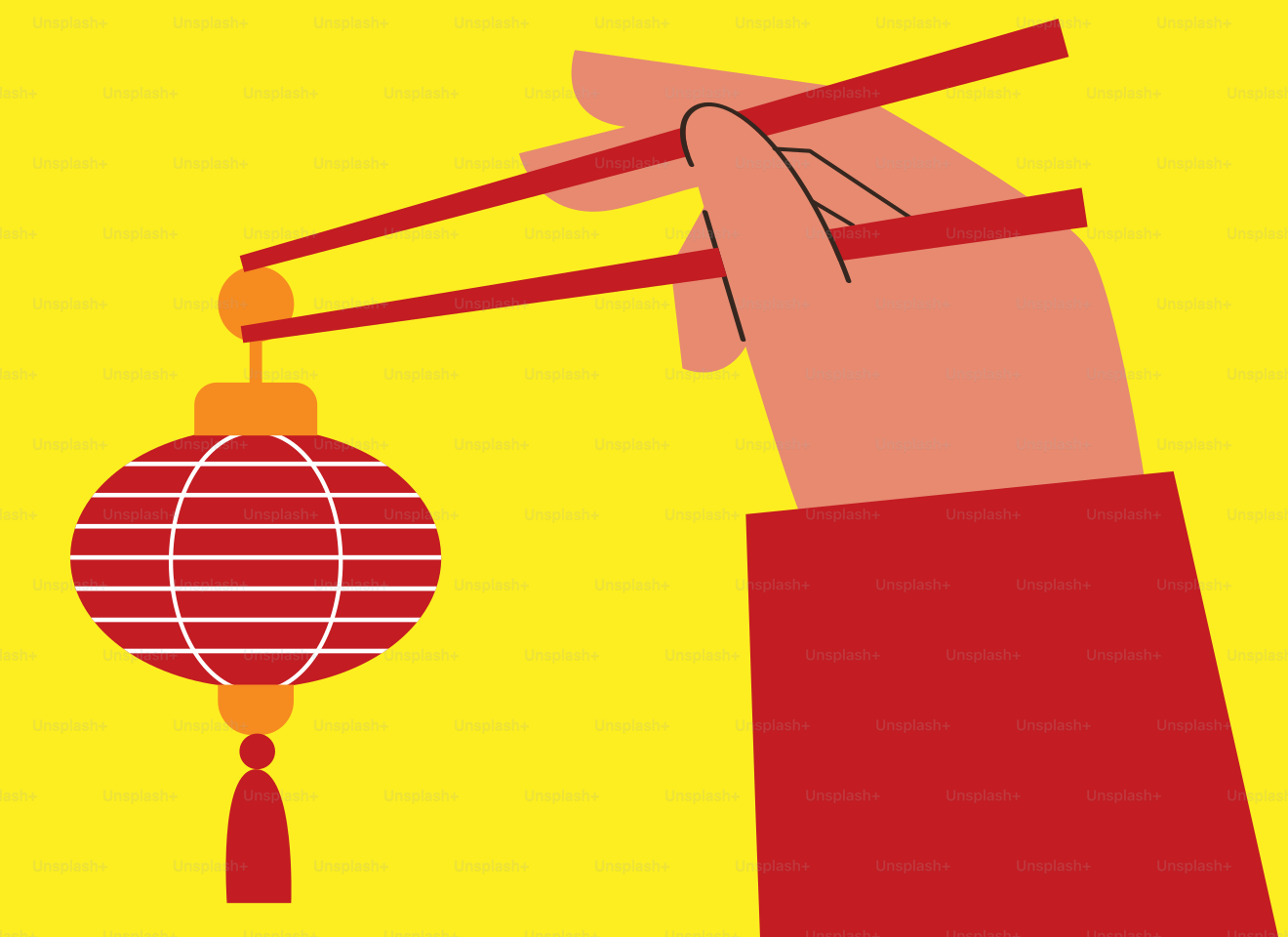 Une main tenant des baguettes sur un fond jaune