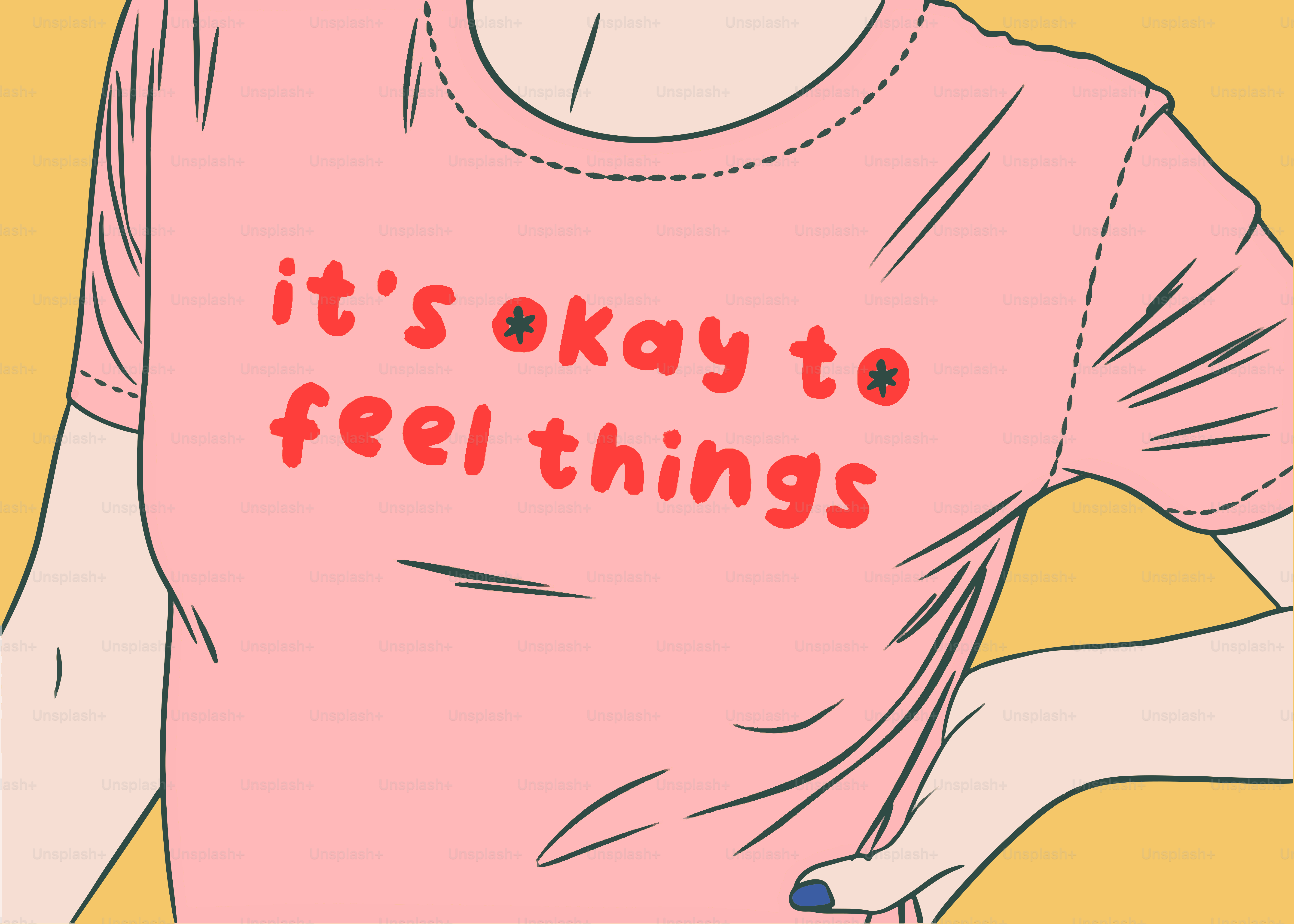 A woman wearing a pink shirt that says it's okay to feel things