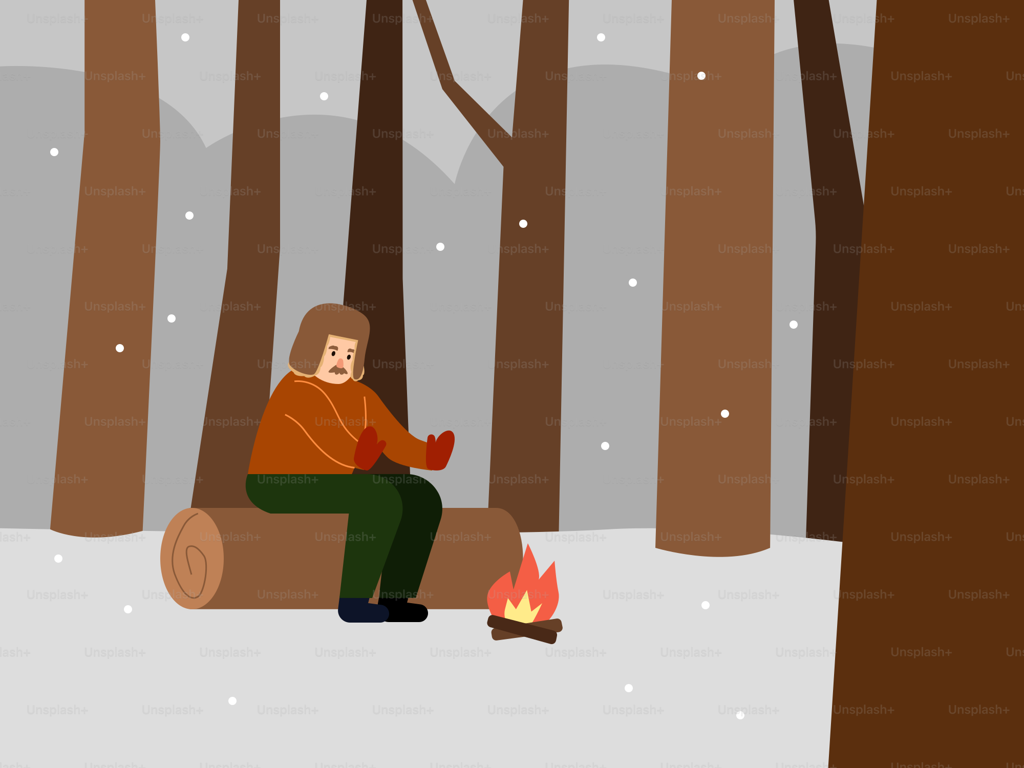 A man sitting on a log in a snowy forest