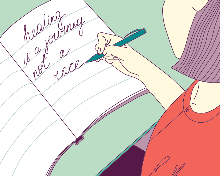 A woman writing on a notebook with a pen