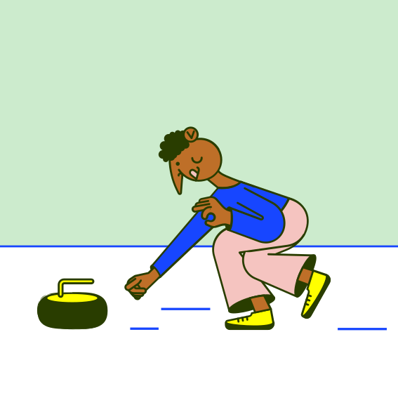 A man kneeling down to pick up a frisbee