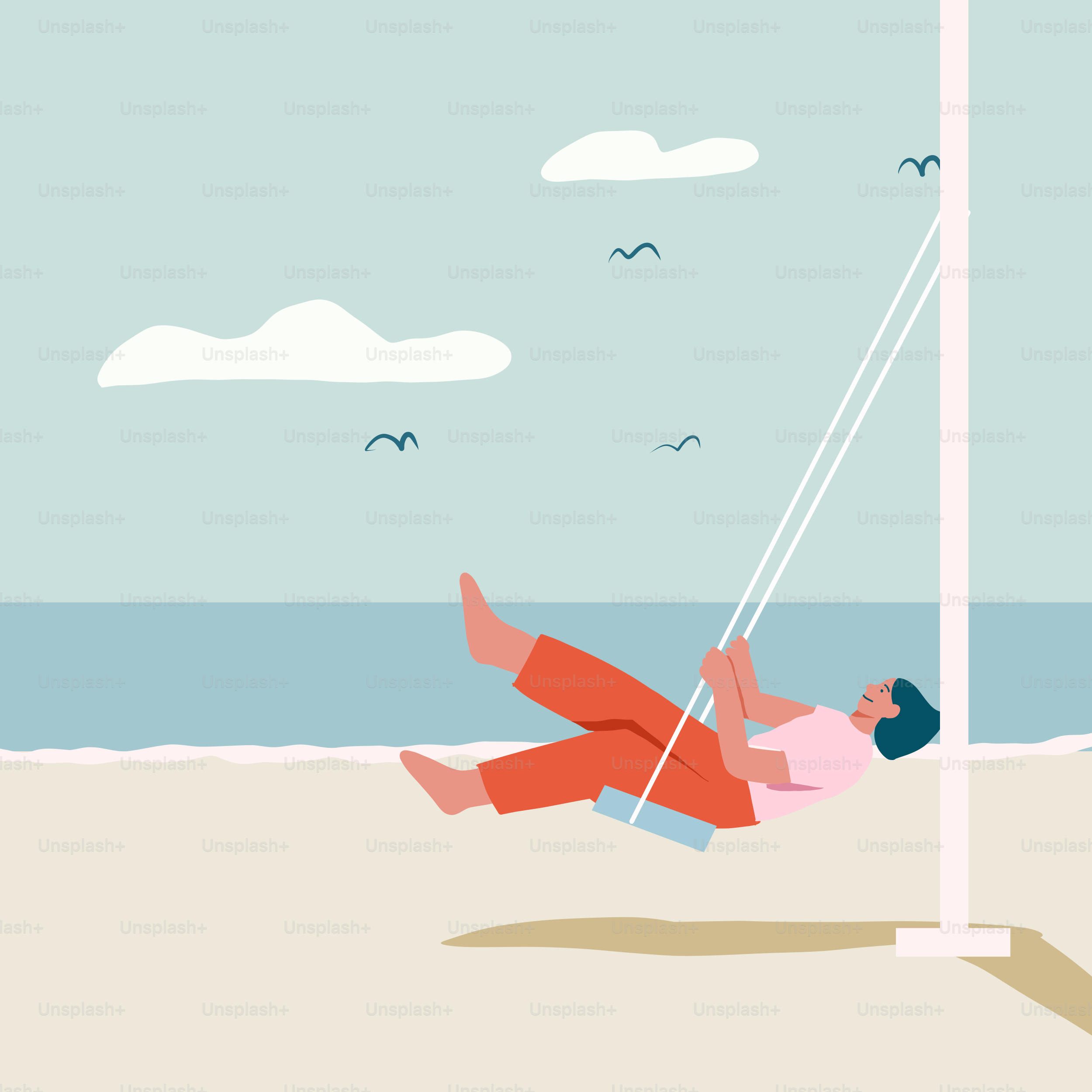 A man is swinging on a rope at the beach
