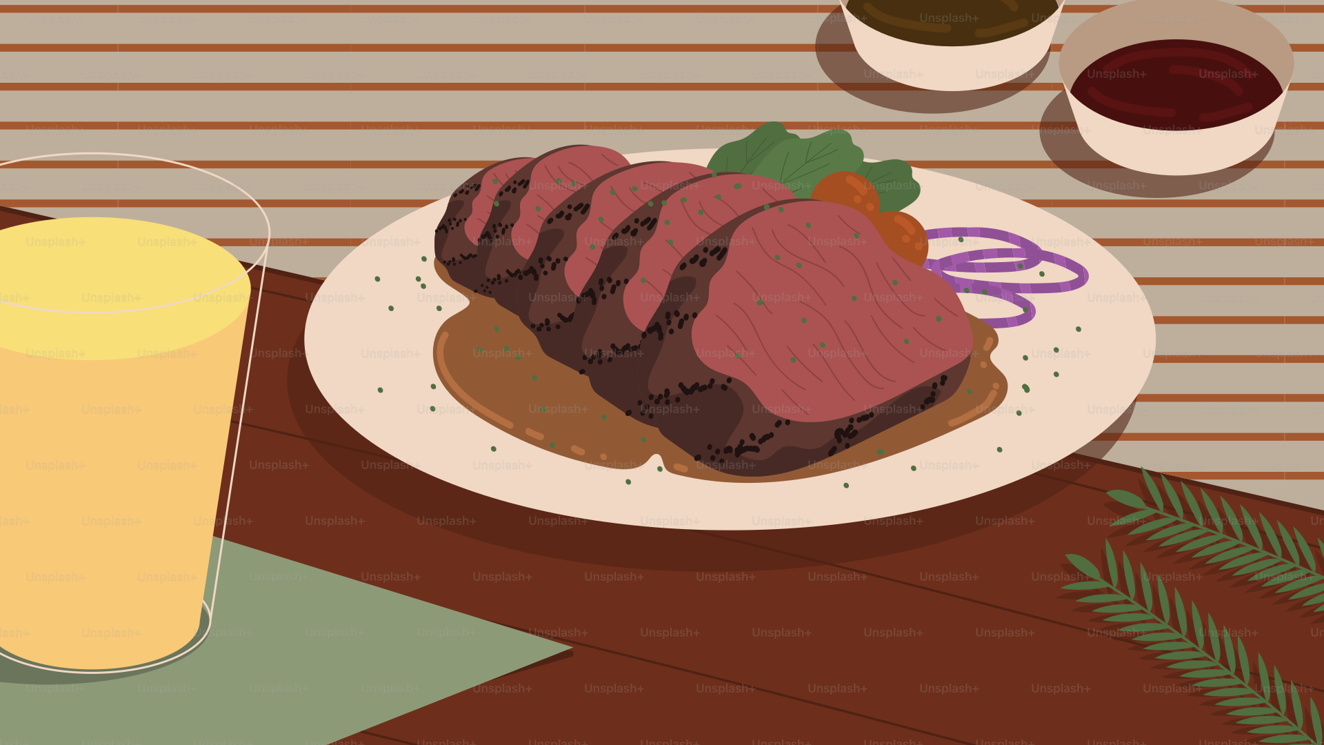 A plate of meat and a glass of orange juice