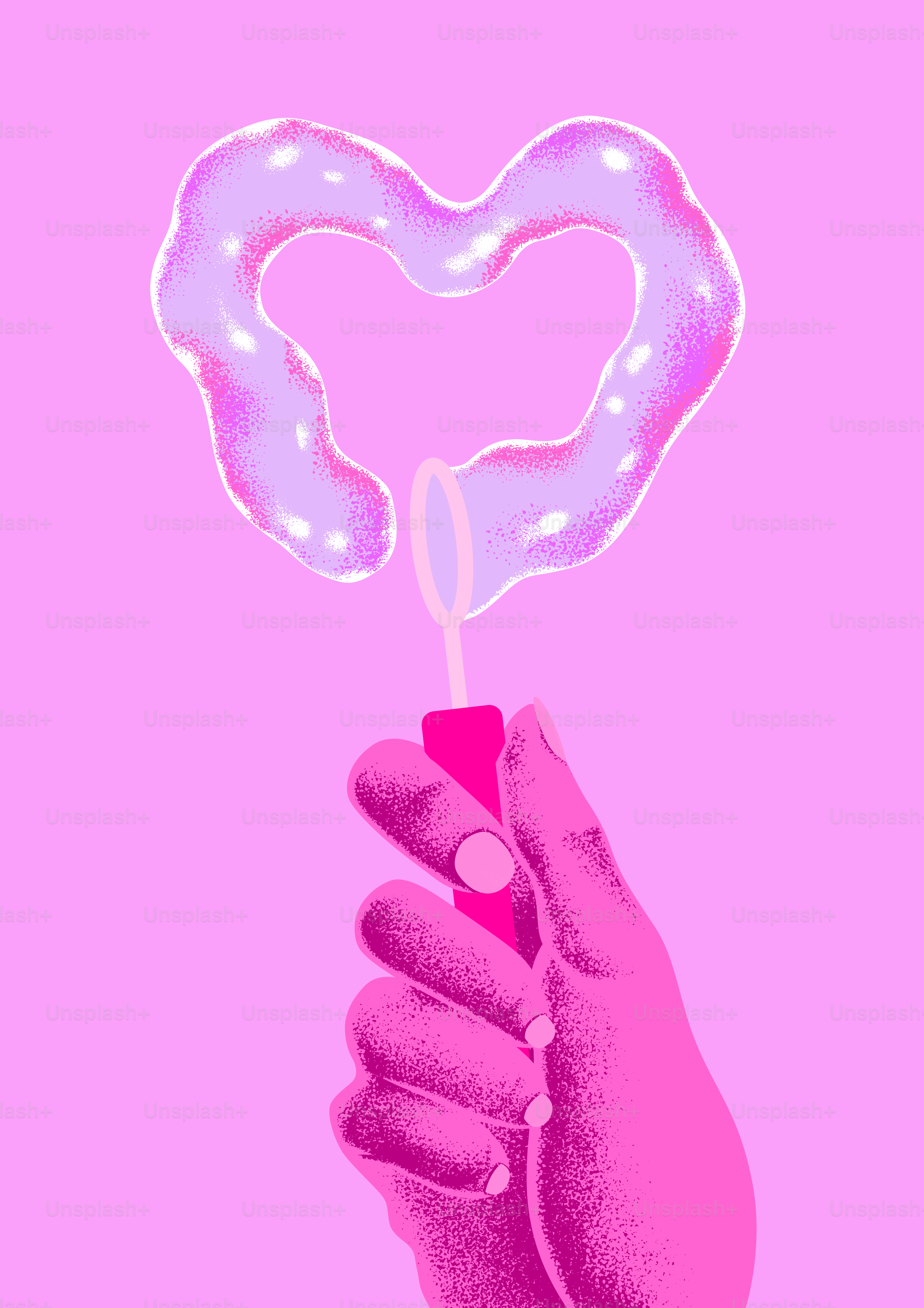 A hand holding a donut shaped like a heart