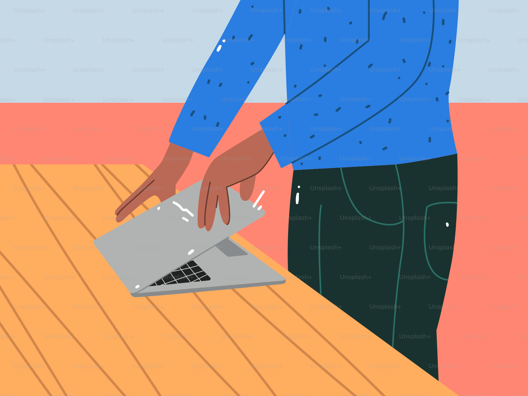 A person using a laptop on a wooden table