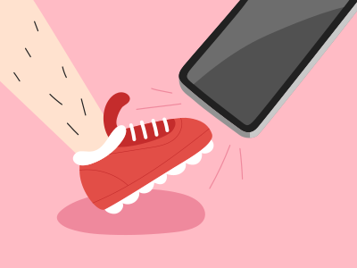 A person kicking a red shoe with a cell phone